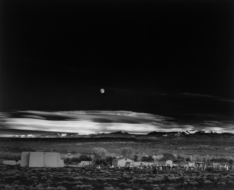 Black and white photo of a moonlit landscape.