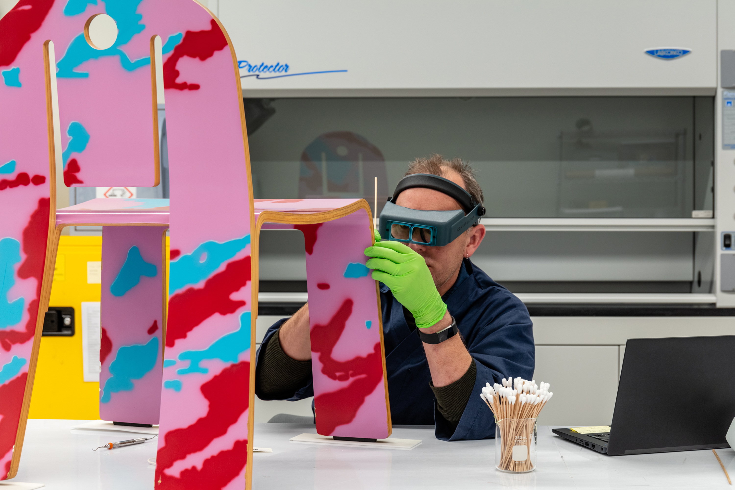 A conservation staffer using tools to clean an object