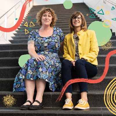 Becky Wareing Steele and Libby Barbee sitting on the steps of the museum staircase