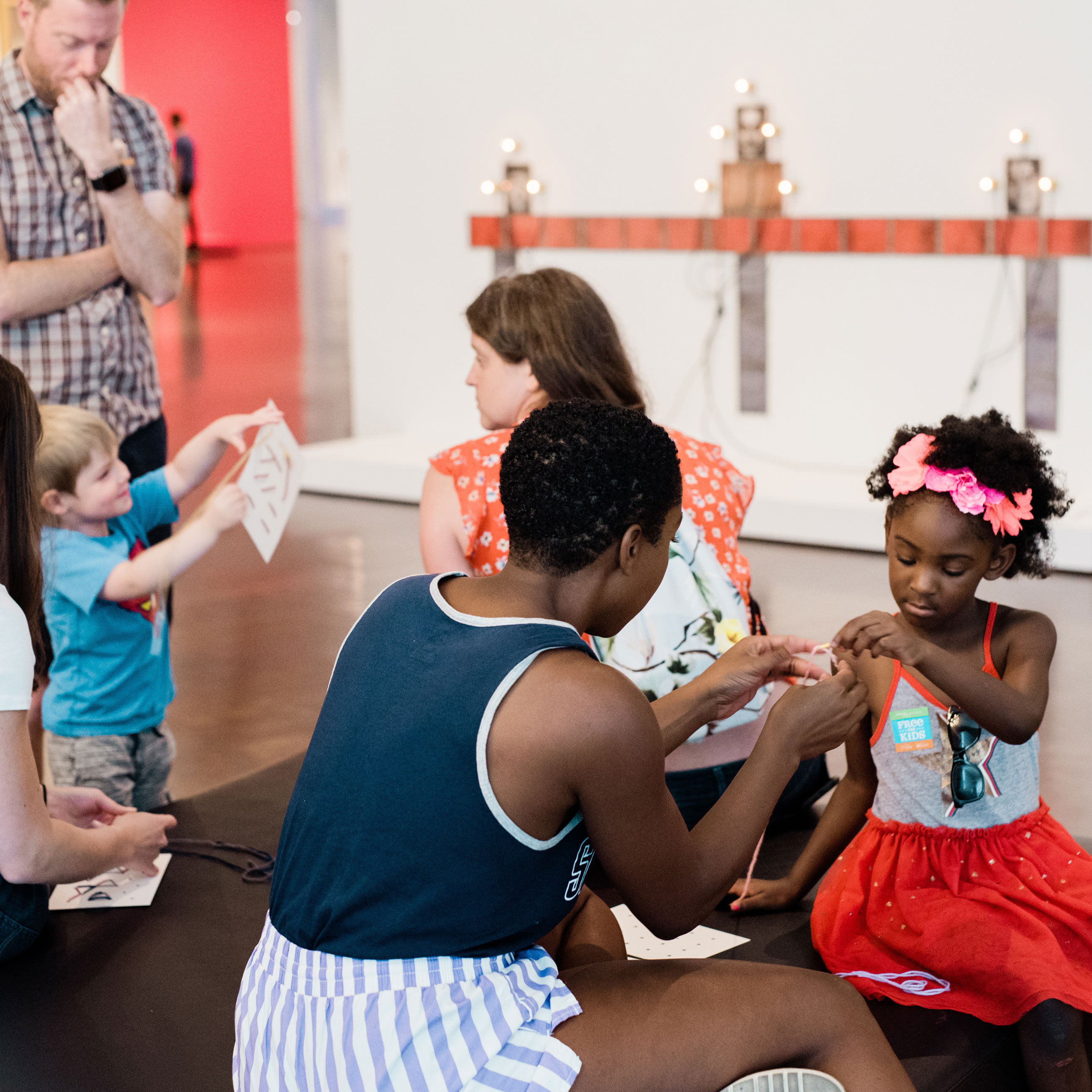 families doing art activities in an exhibition at the Denver Art Museum