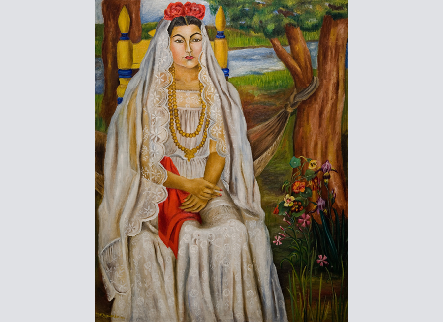 Woman in bridal clothing posing for a portrait.