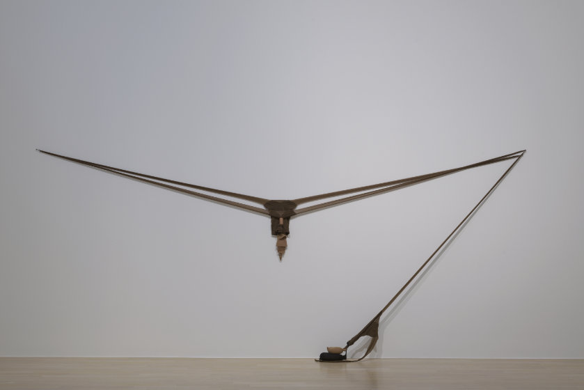 Two pairs of nylon pantyhose stretched in a 12 foot wide V-shape. A third pair of pantyhose, weighted with sand, stretches diagonally from the right corner of the V-shape to the ground.