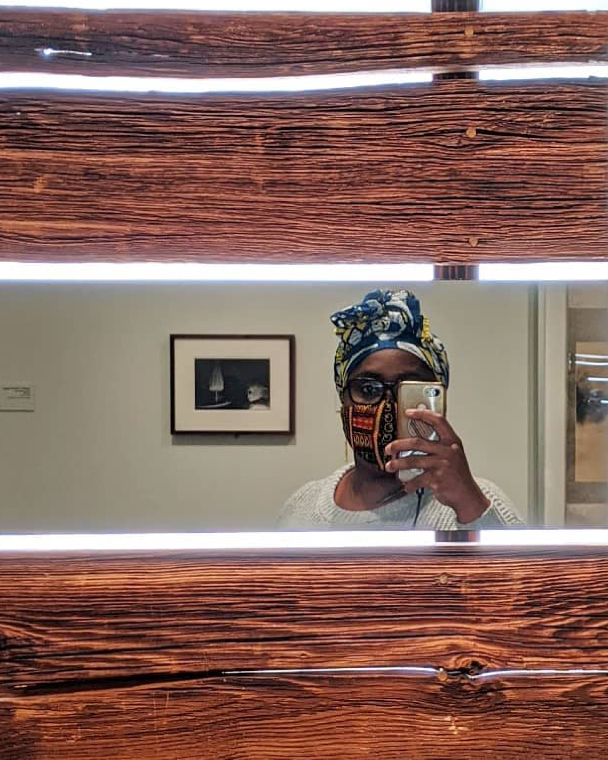Museum visitor taking a picture of herself in a reflection