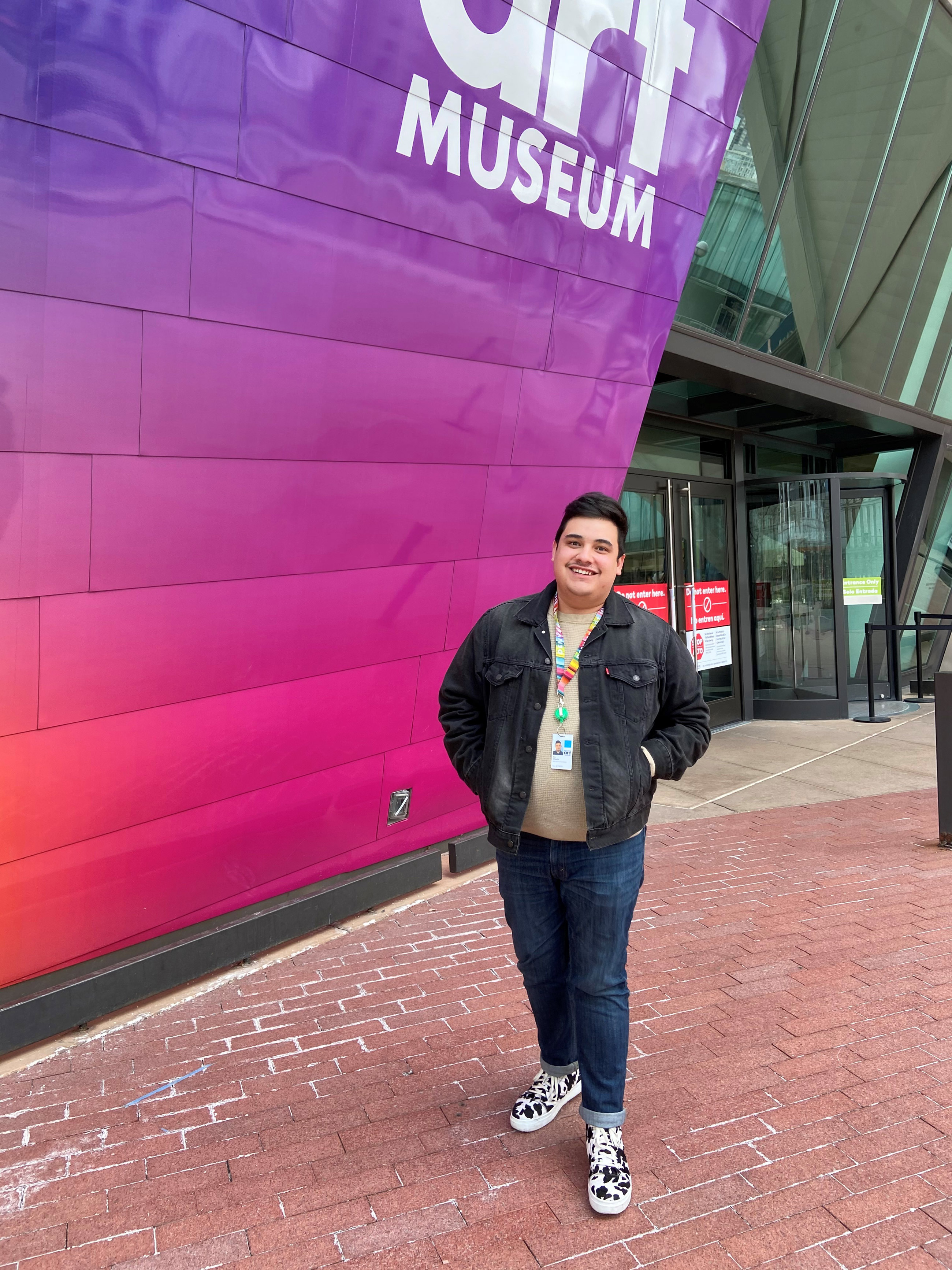 Aric Wheeler stands in front of the Denver Art Museum entrance