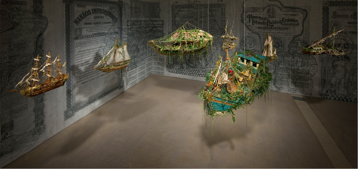 Art installation of suspended boats created by Hew Locke called "Off Shore Drift"