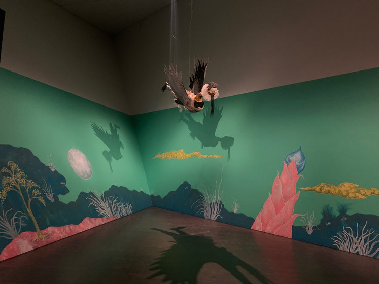 A colorful mural painted on two angled walls in the Denver Art Museum.