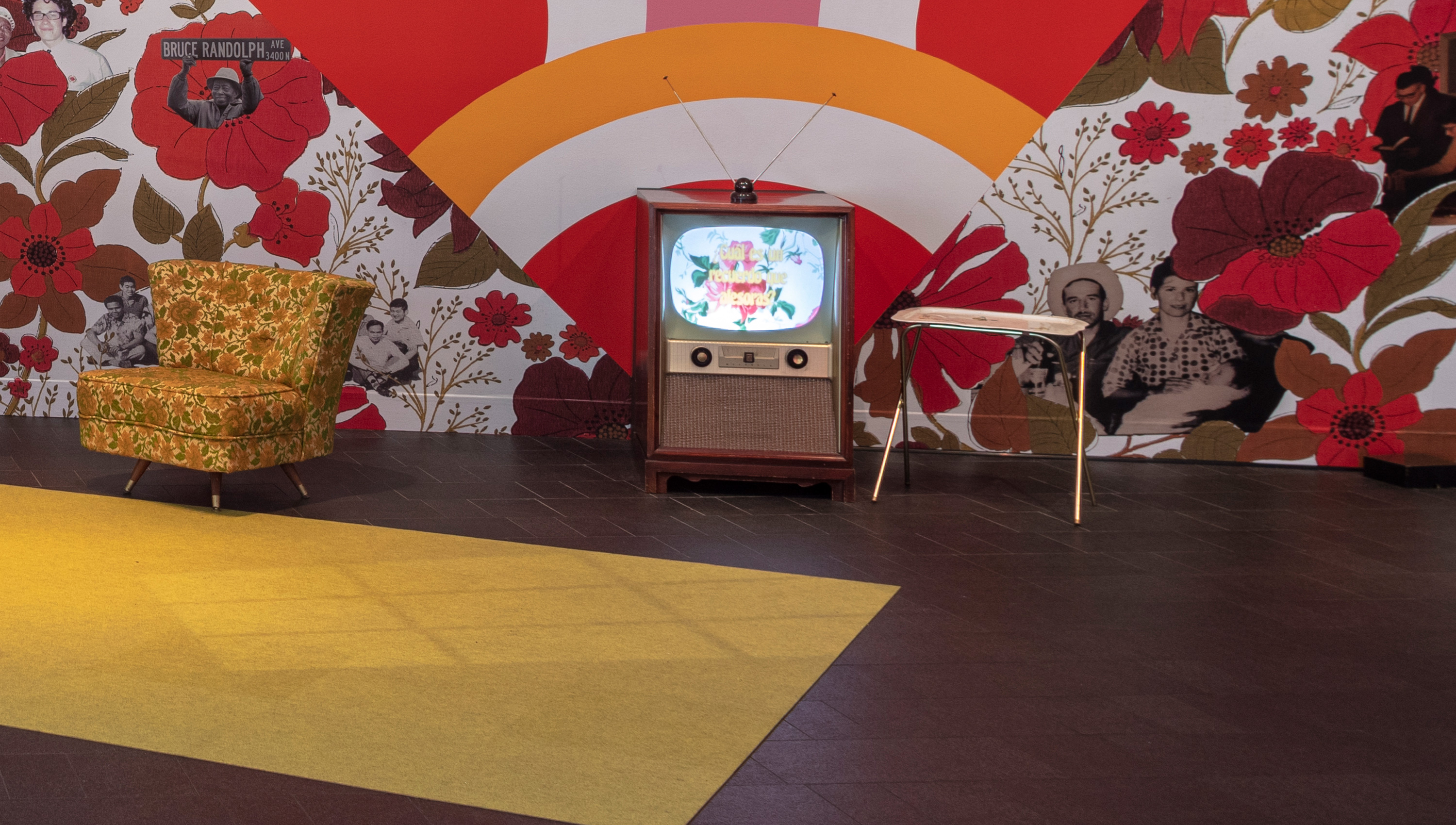old-fashioned tv and furniture in front of old-fashioned wallpaper in Memory Mirror exhibition
