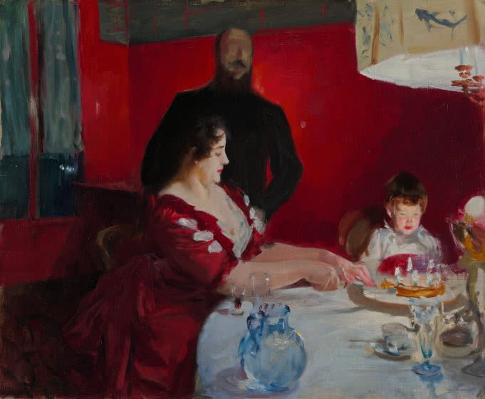 A painting of a woman in a red dress sitting at a table and cutting the birthday cake for a young child.