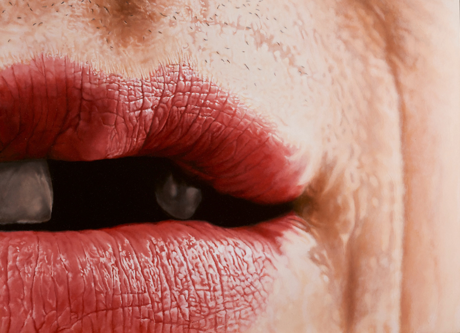 Close-up image of a woman's mouth with a hint of stubble