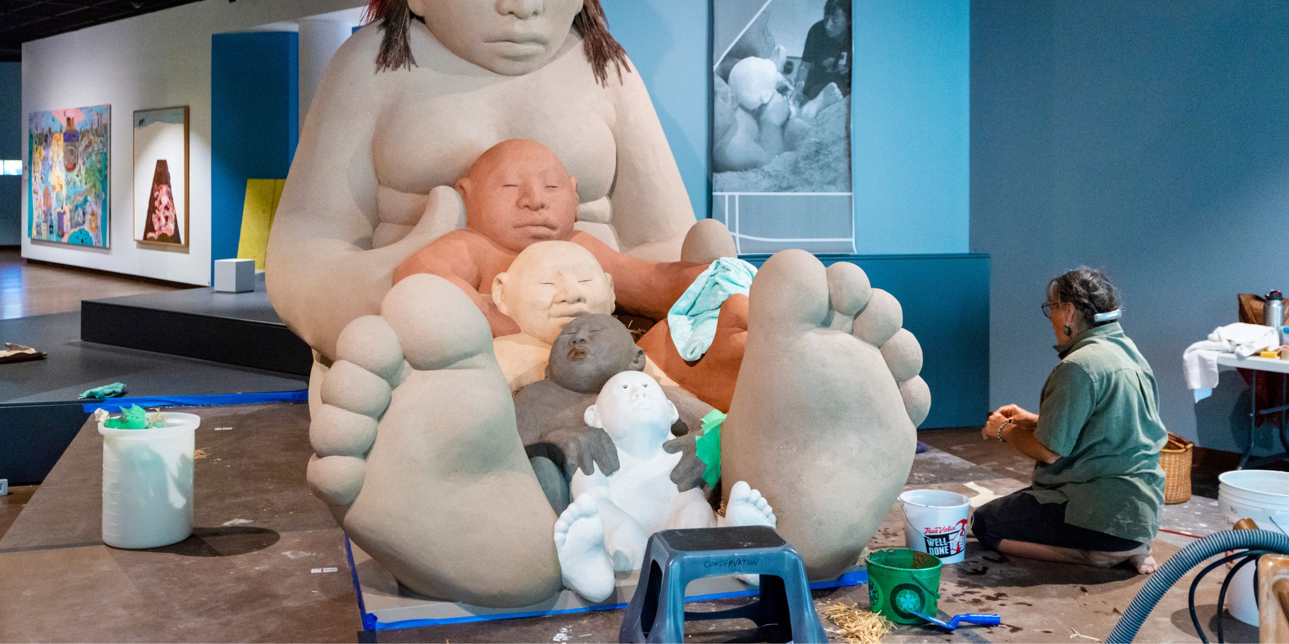 A conservationist working on &quot;Mud Woman&quot; at the Denver Art Museum.