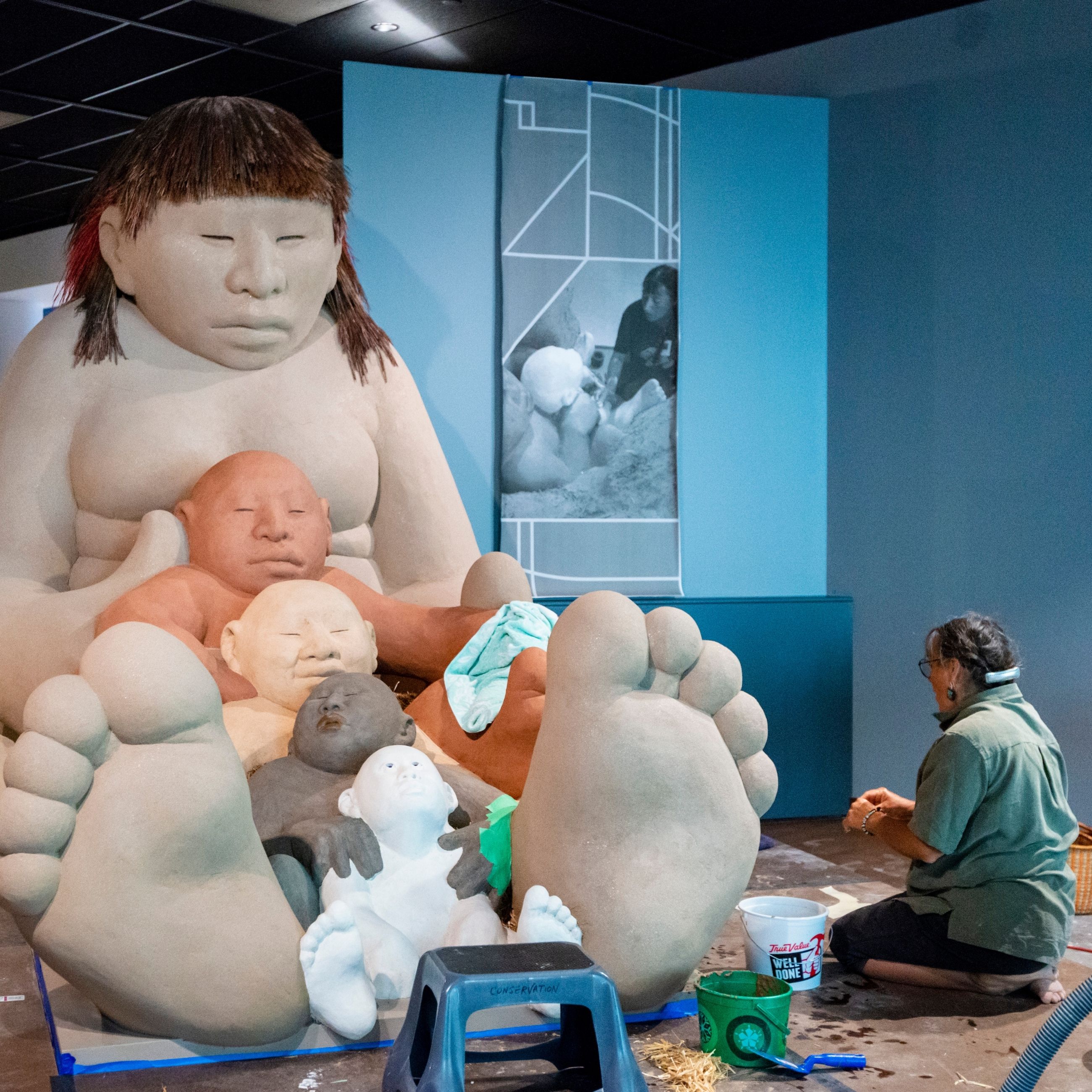 A conservationist working on &quot;Mud Woman&quot; at the Denver Art Museum.