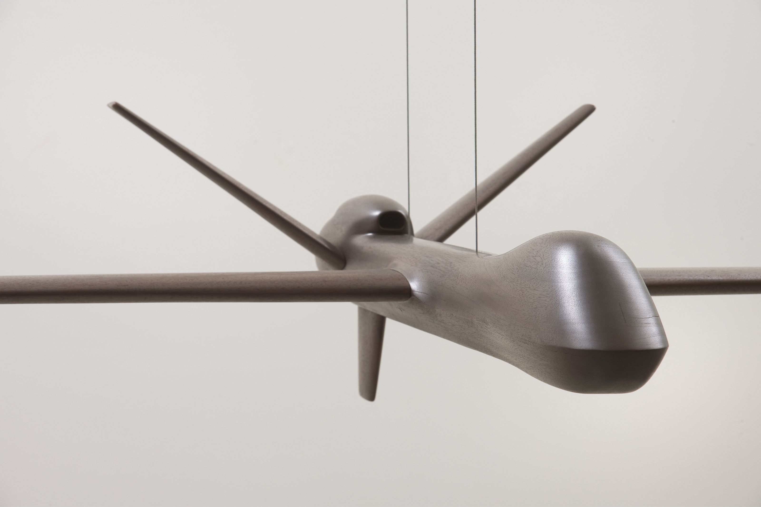 Sculpture of an airplane made out of mahogany and graphite.