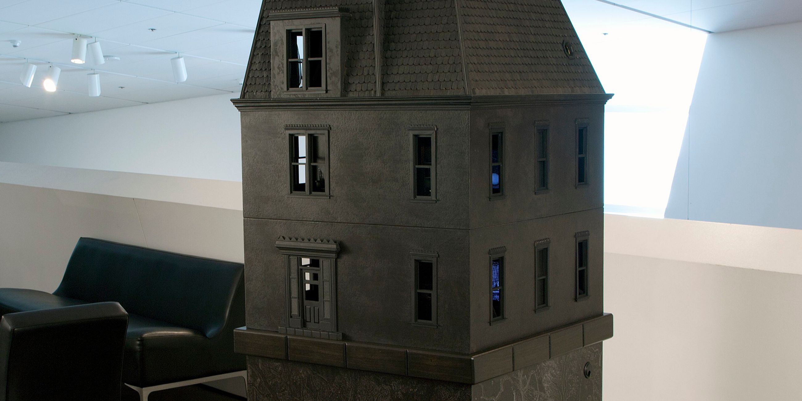 Inside Stacey Steers’s fully furnished Victorian dollhouse, miniature TVs play excerpts from "Night Hunter."
