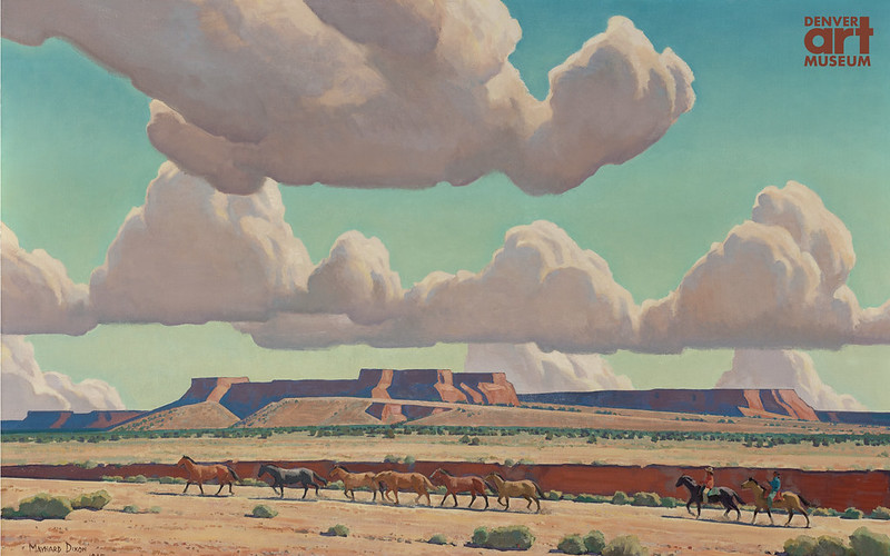 Two men on horseback and several other horses crossing the Navajo plains
