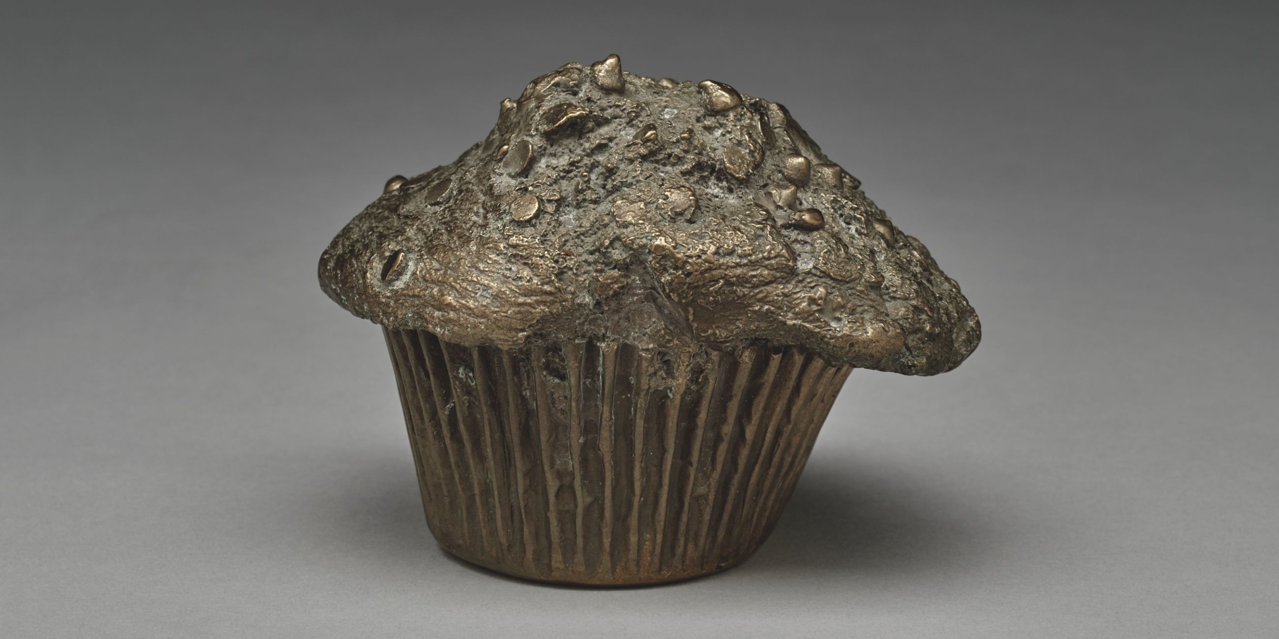 Bronze sculpture of a chocolate chip muffin by artist Jude Tallichet.