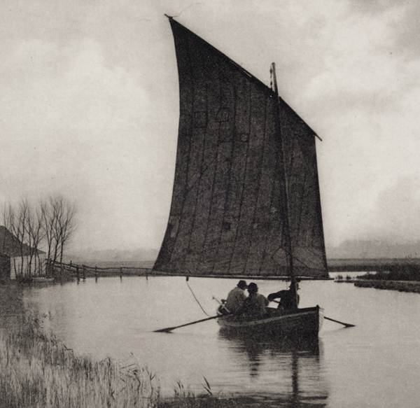 Black and white photograph of men in a sailboat