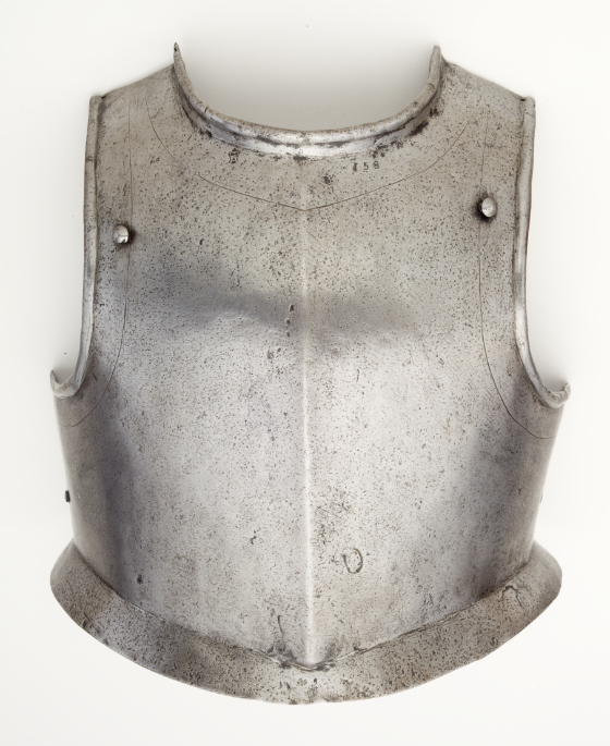 A silver, short-waisted breastplate with a slightly overhanging waist flange. Undecorated except for a single engraved line that follows the perimeter of the piece around armpits and neck, and several engraved stamps near the neckline.