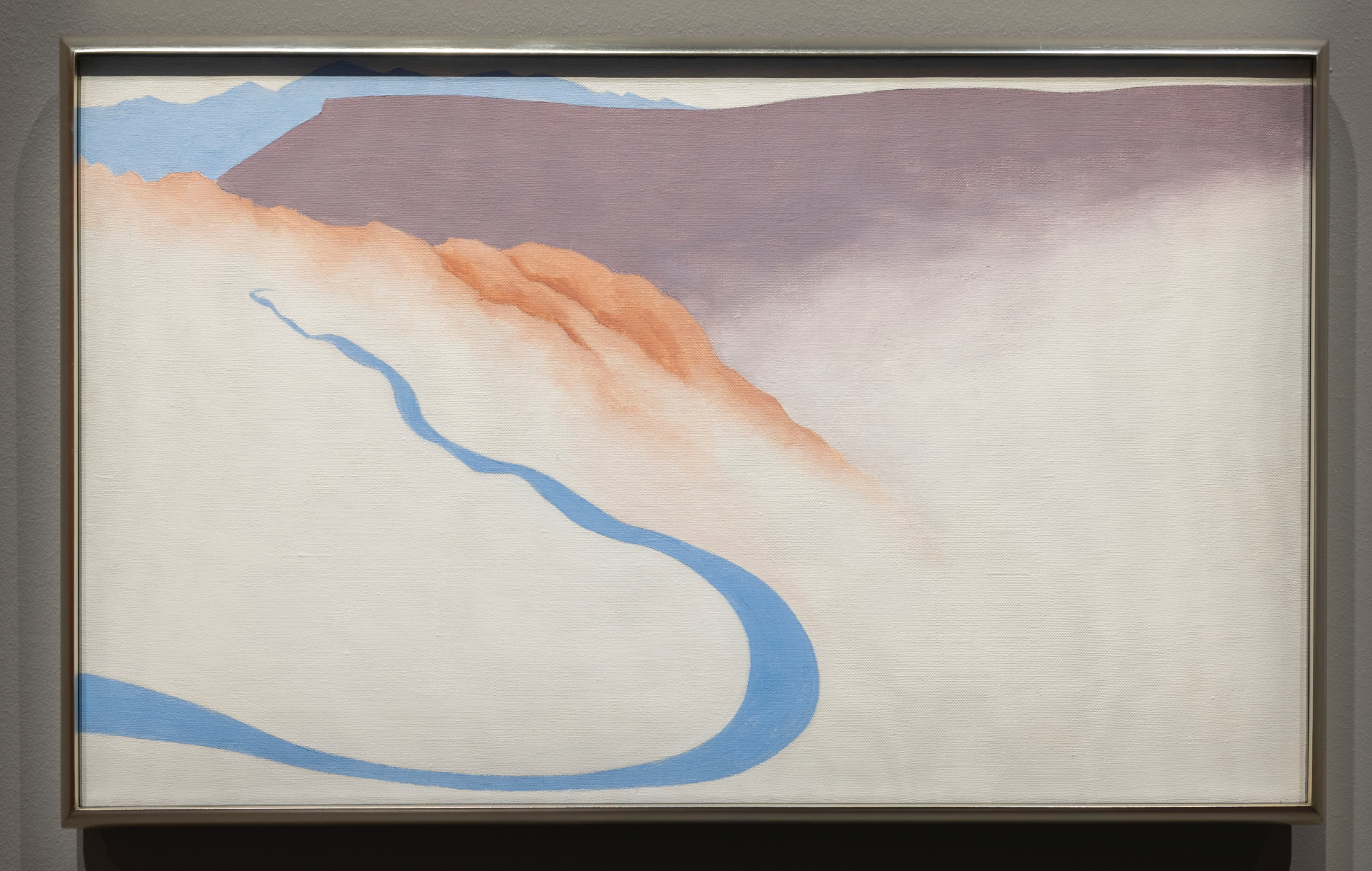 Abstract color painting of a blue road curving upward into a mountain range.