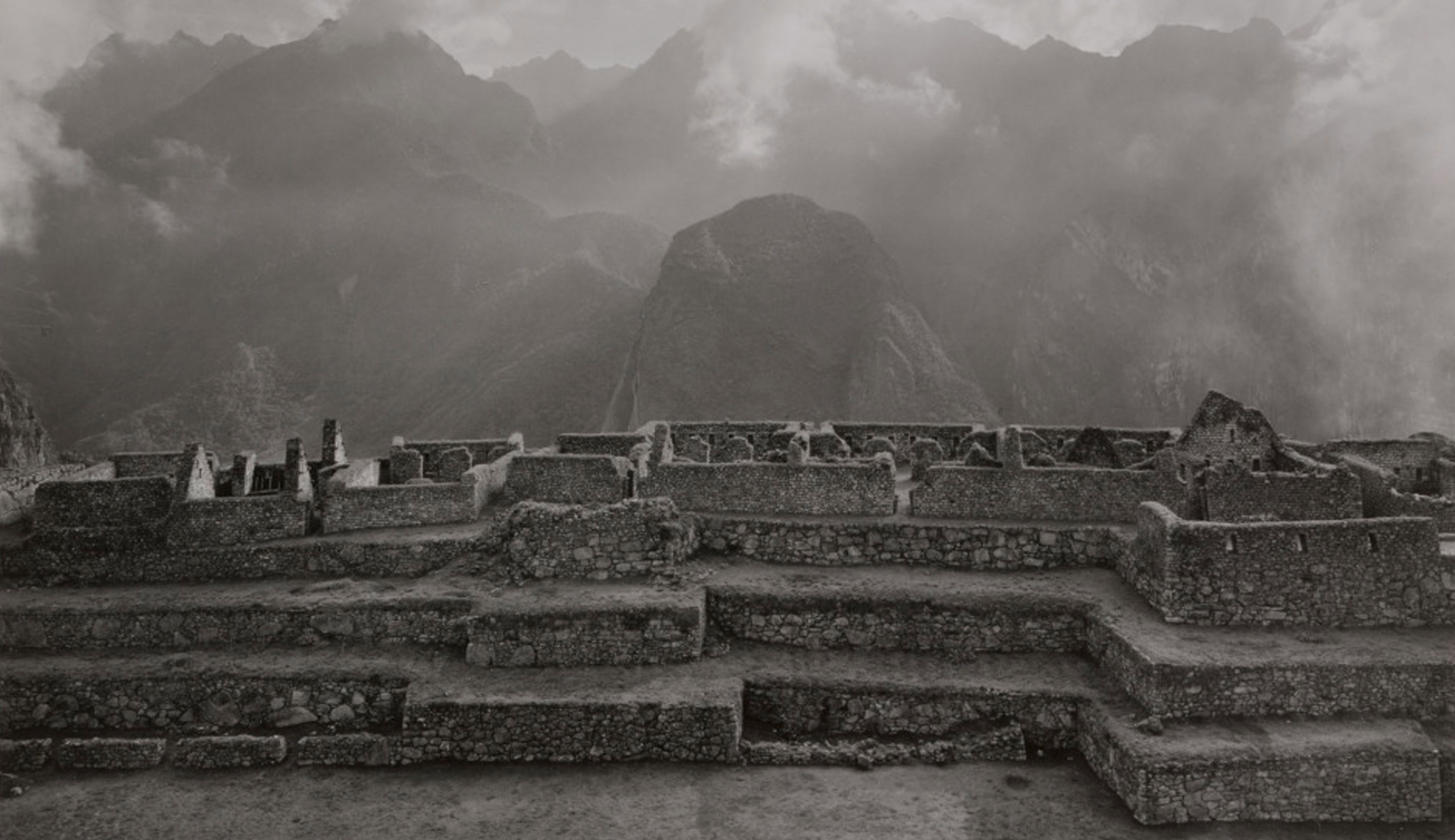 Black and white photograph of Machu Picchu on a cloudy day