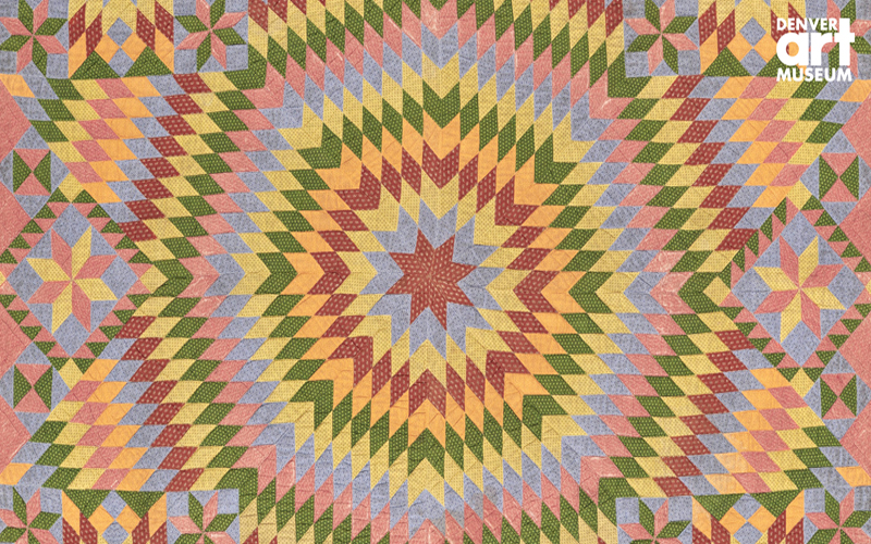 Brightly colored quilt with symmetrical shapes forming a star