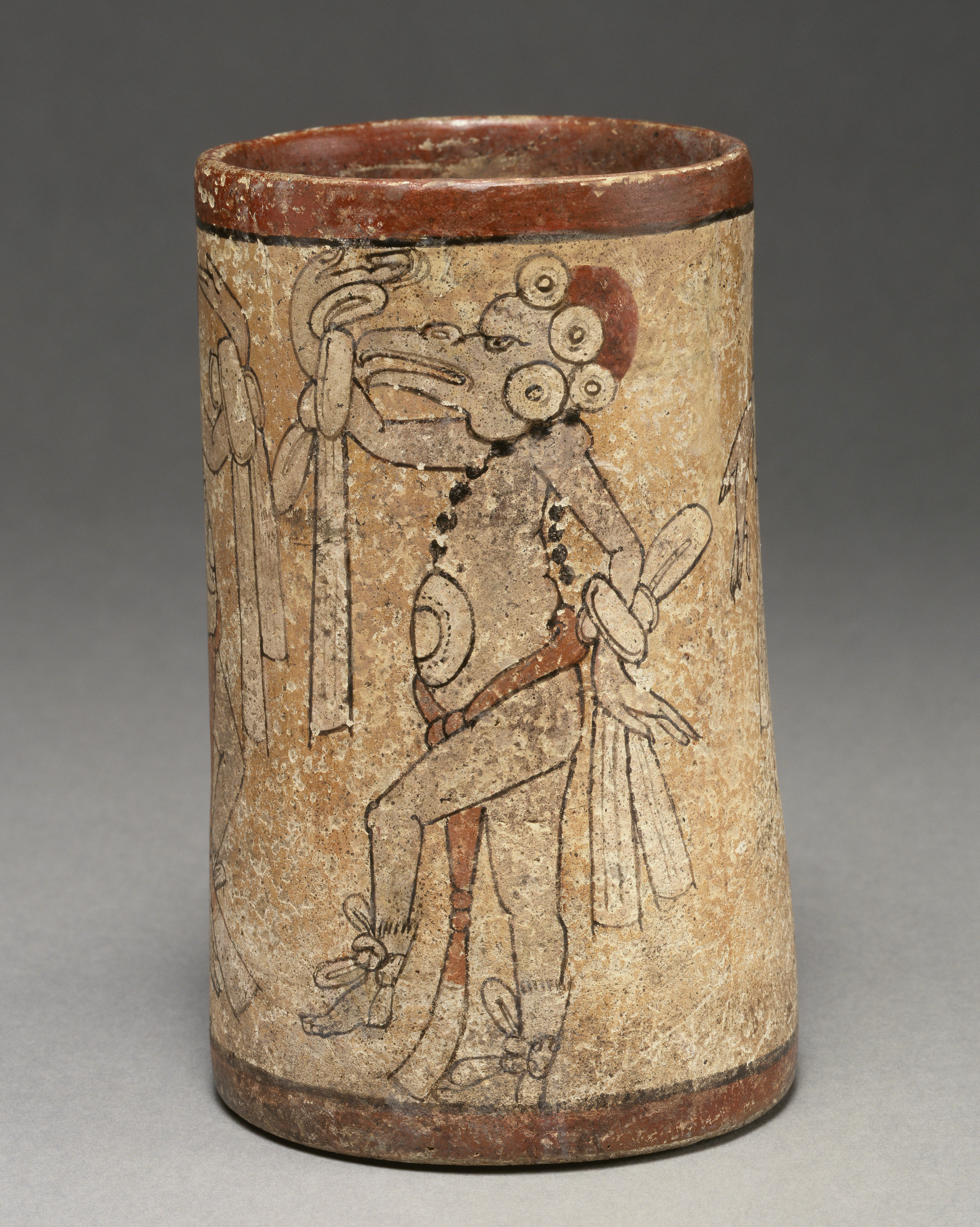 Detail of a clay vessel with a painted image of a bird-headed dancer.