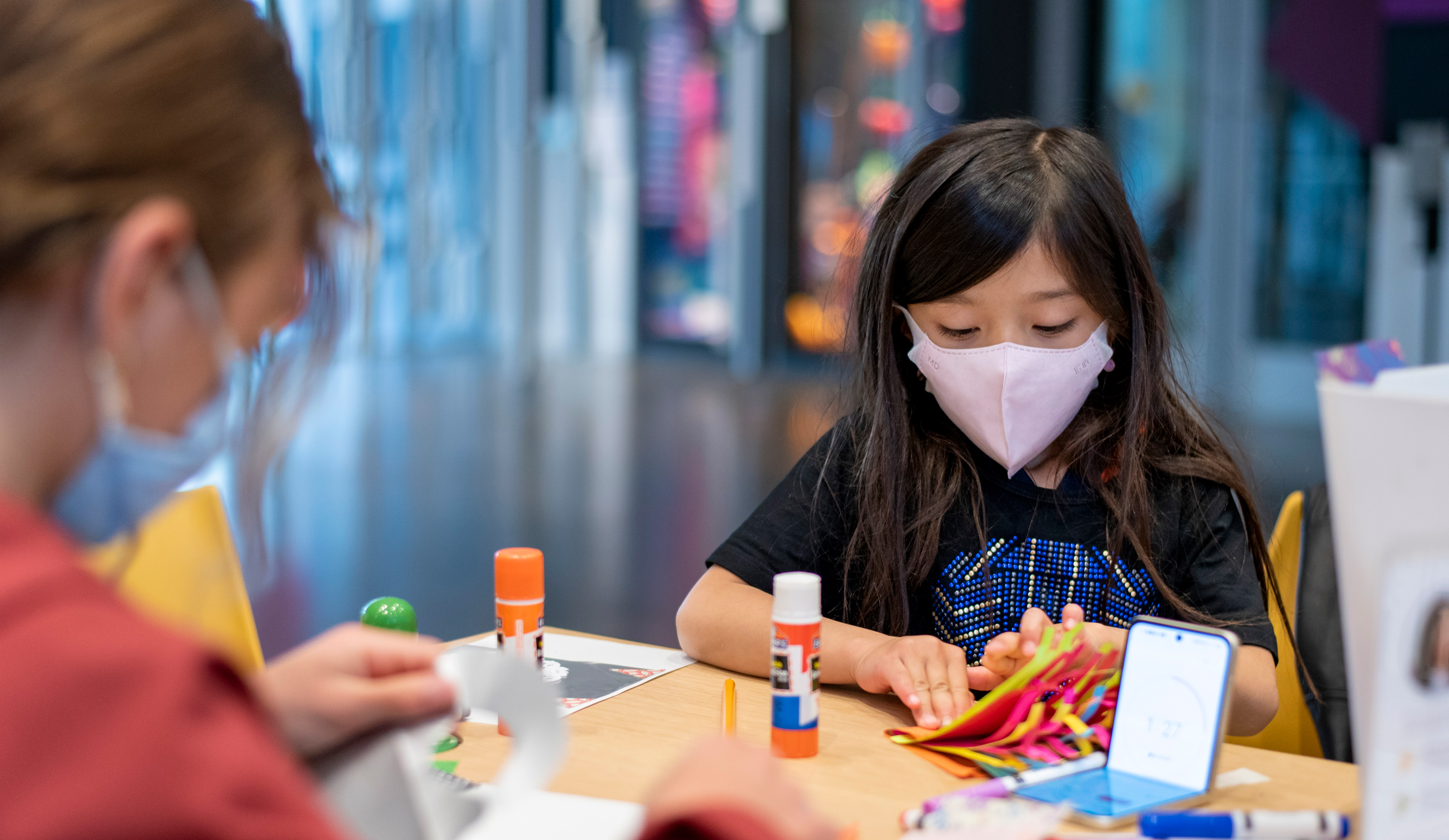 Young masked girl making art