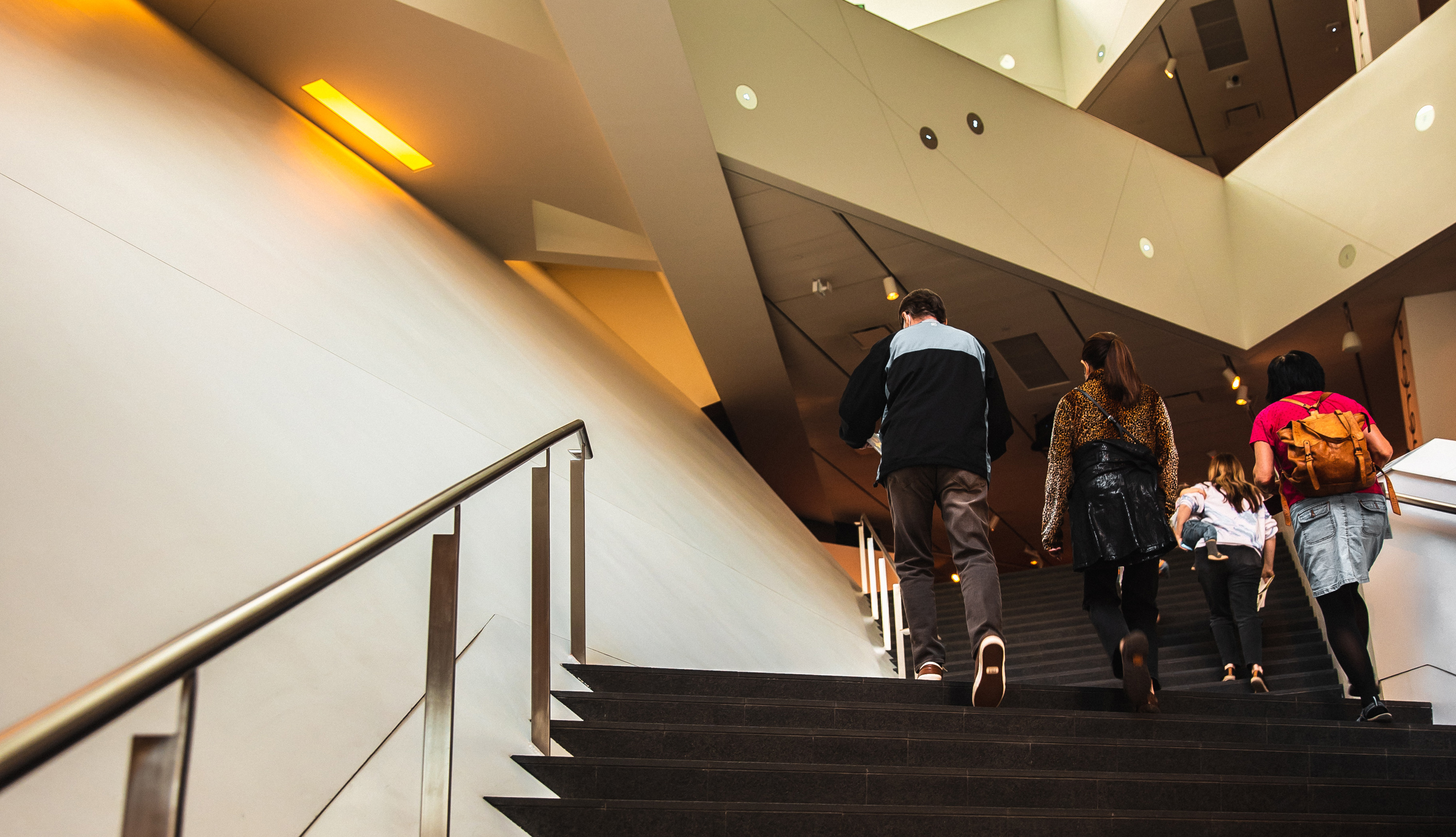 Visitors walking up the steps in the Hamilton Building atrium