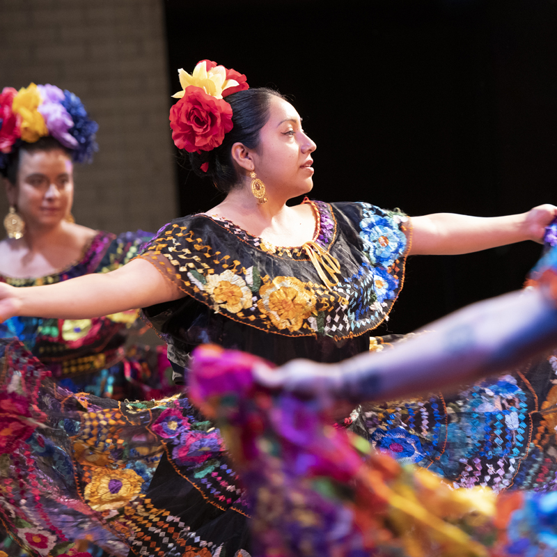Female dancing on stage performing in a Las Adelitas dance