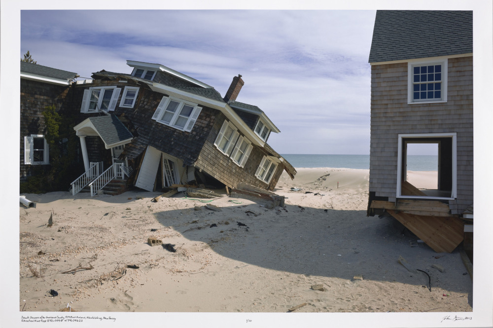 Photograph of a beach house ruined by a hurricane
