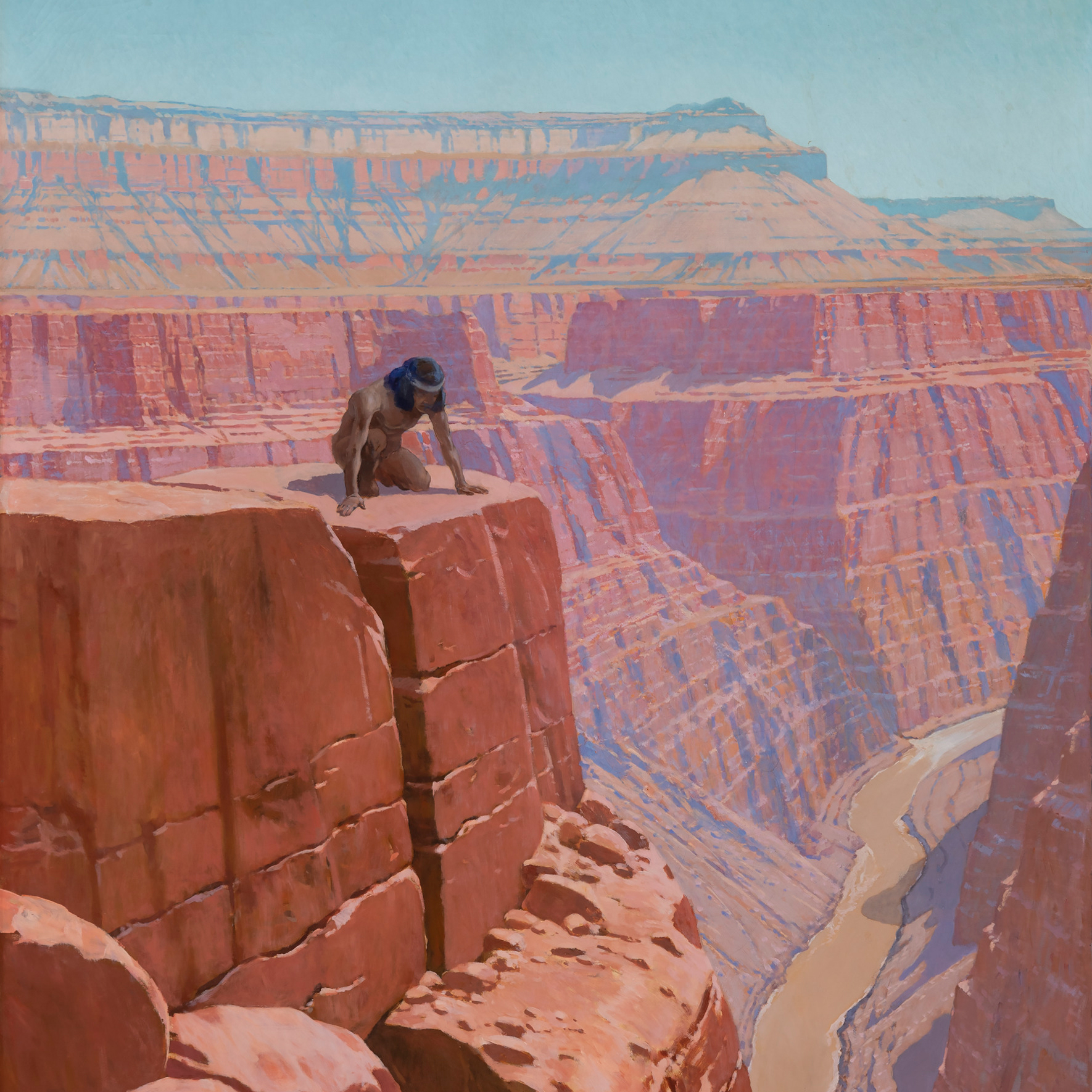 Man peering over the edge of a cliff in the Grand Canyon