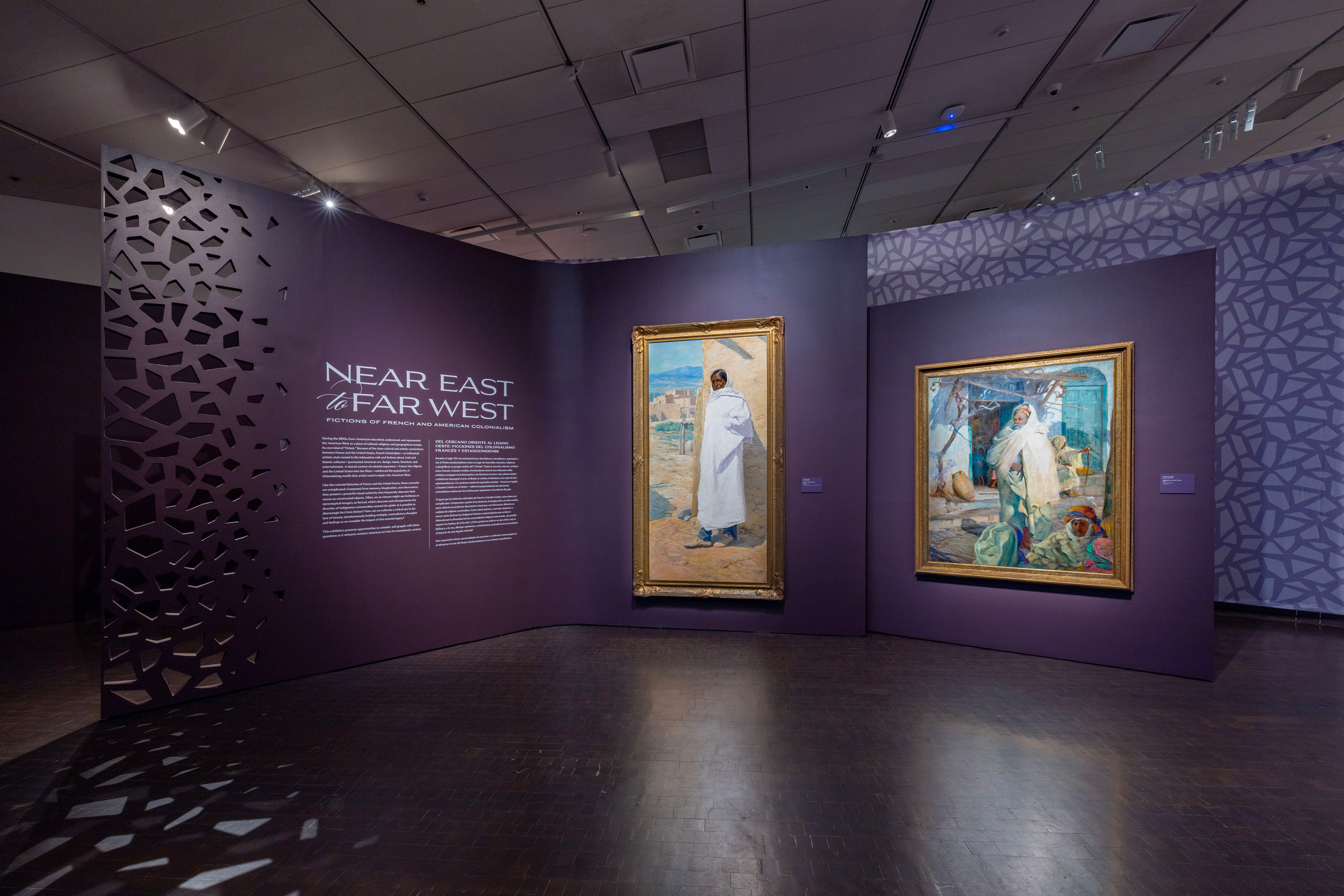 gallery view of Near East to Far West with wall text and two paintings