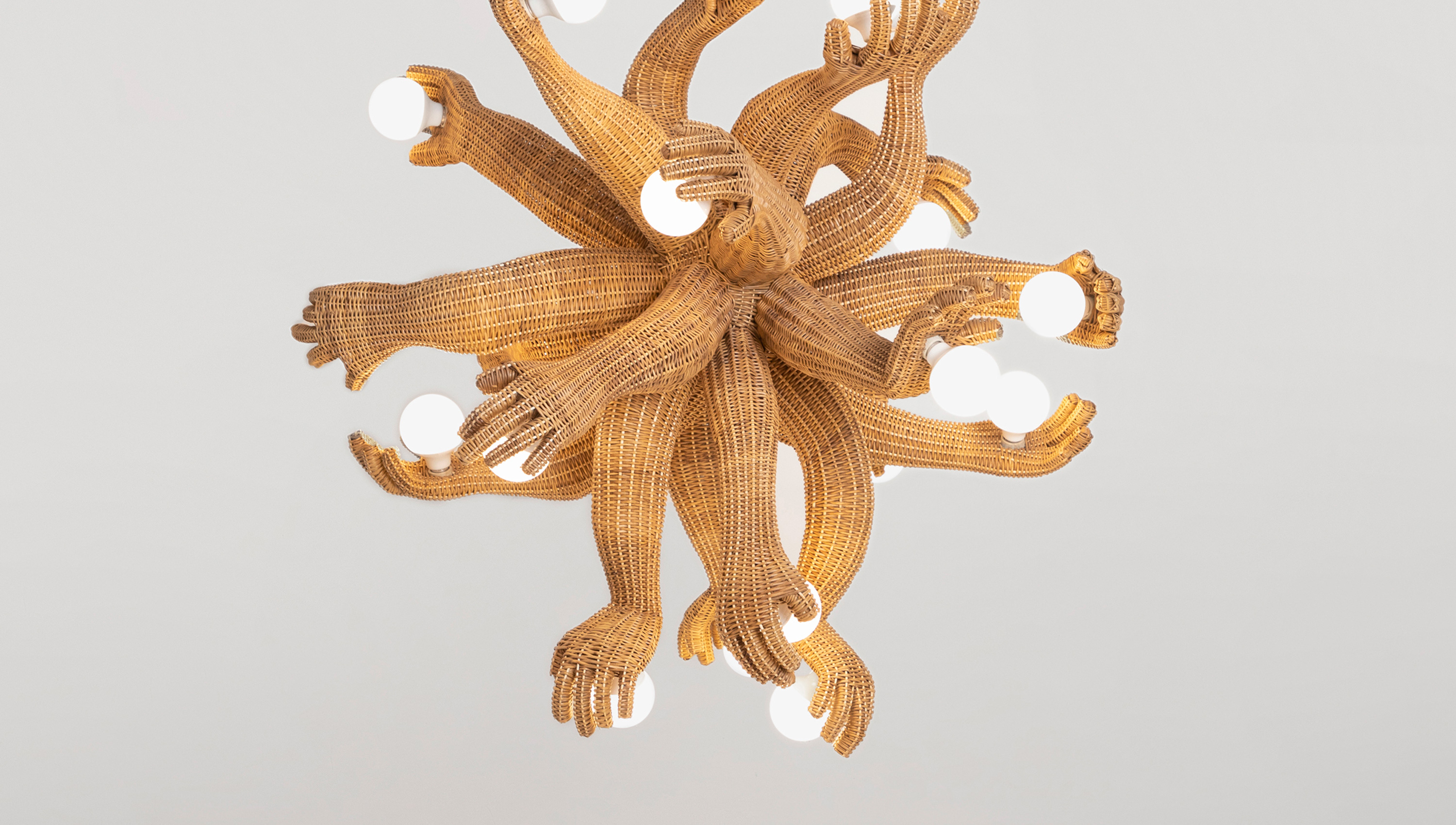 a chandelier that looks like multiple lower arms with the hands holding bulbs