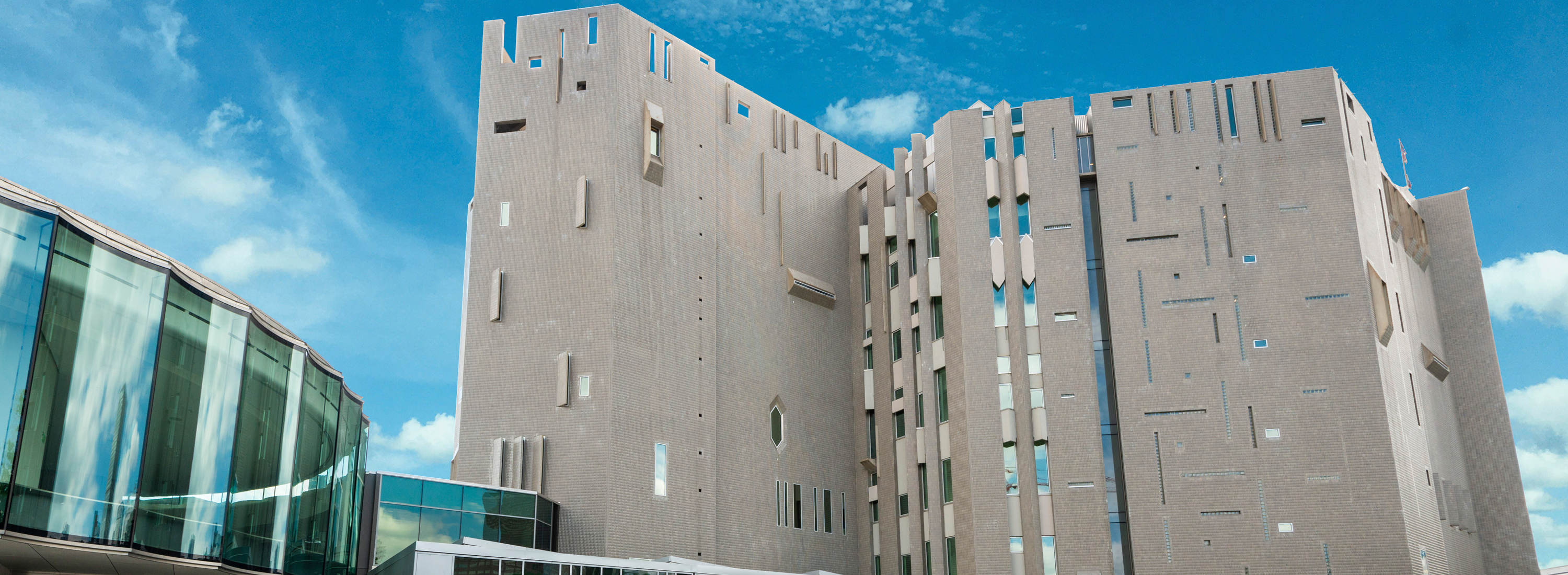 Exterior view of the Martin Building and Sie Welcome Center during a bright, clear day