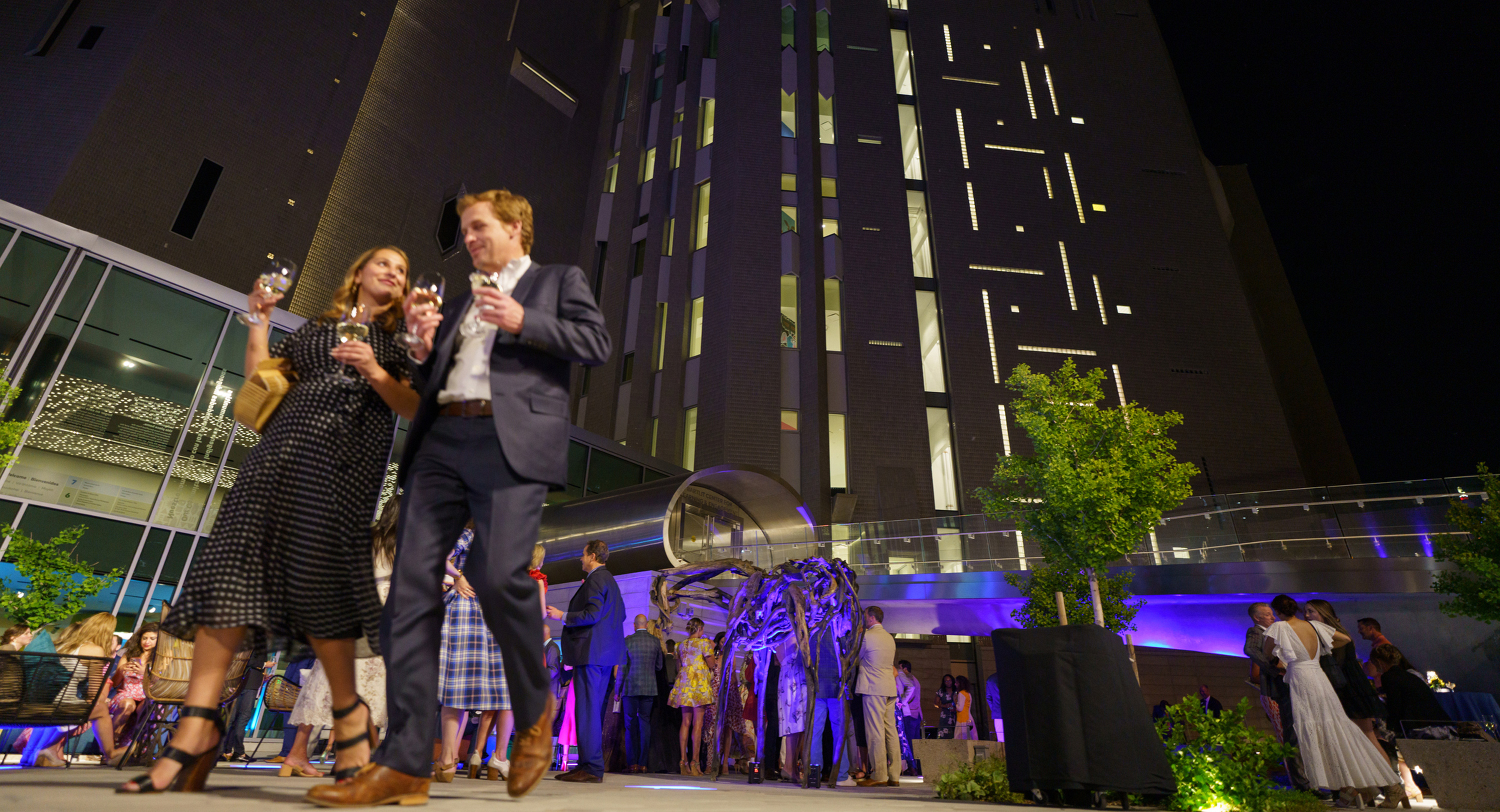 Crowd in formal wear gathered outside the Martin Building at night