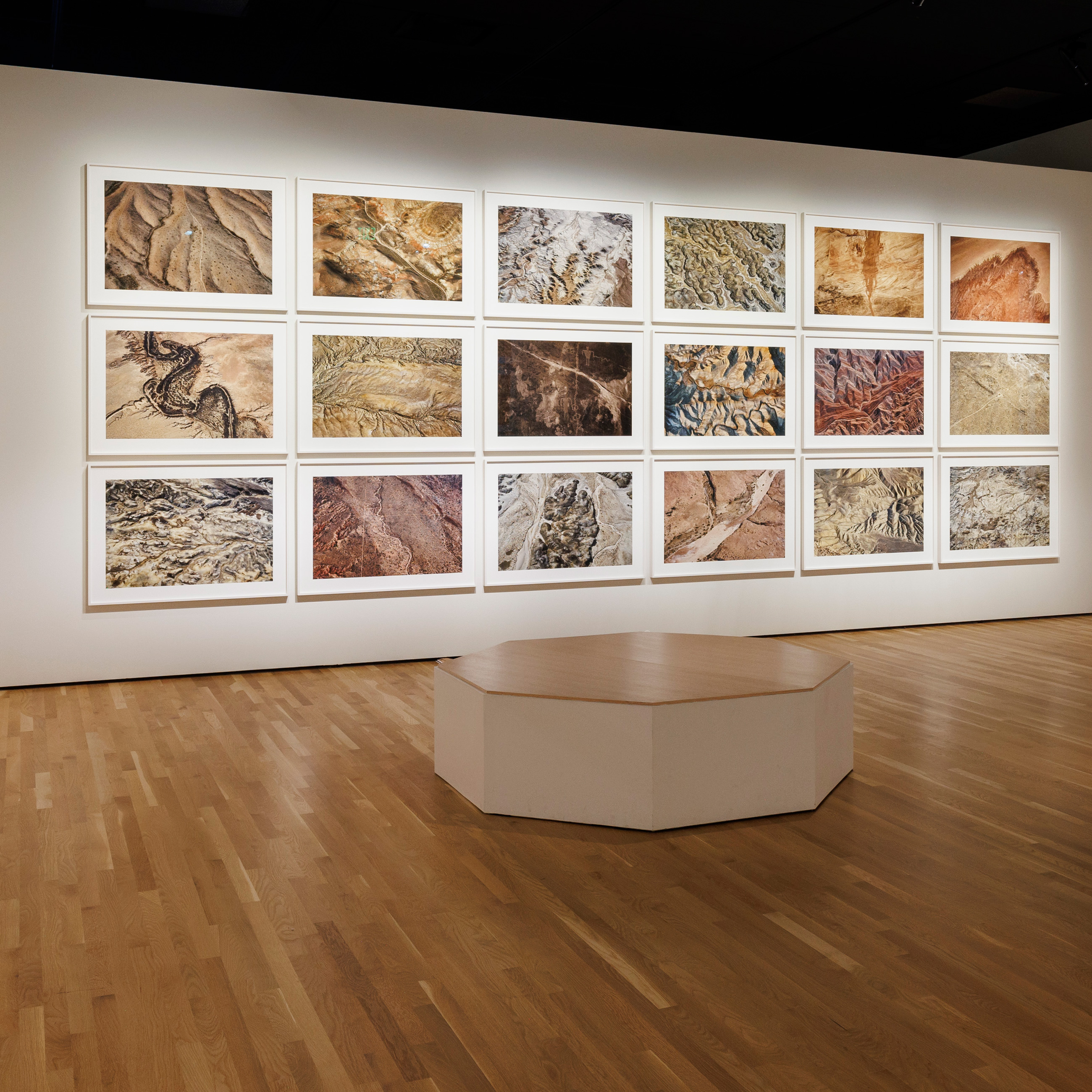 rows of photos by Fazal Sheikh on a gallery wall in the exhibition