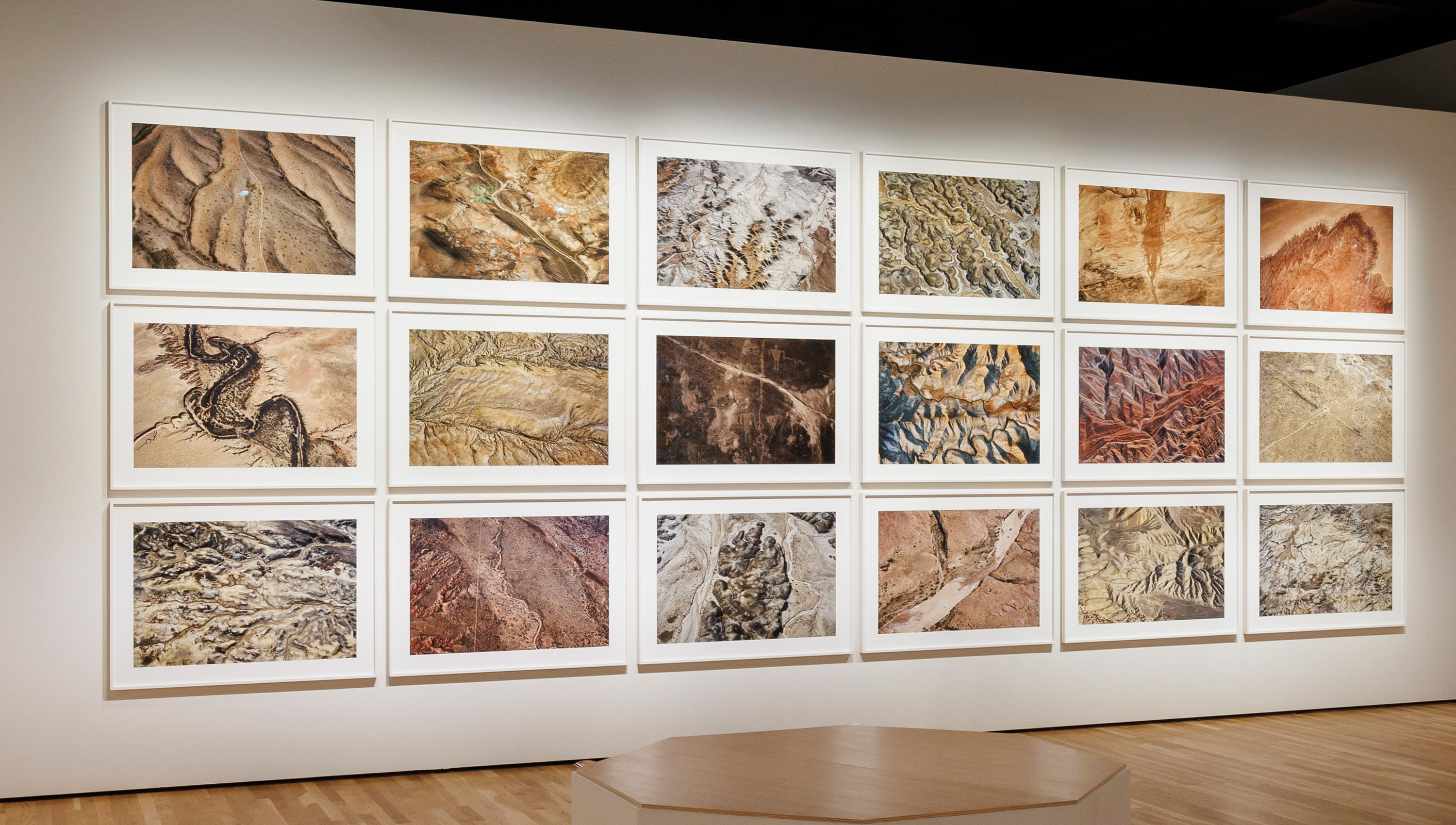 rows of photos by Fazal Sheikh on a gallery wall in the exhibition