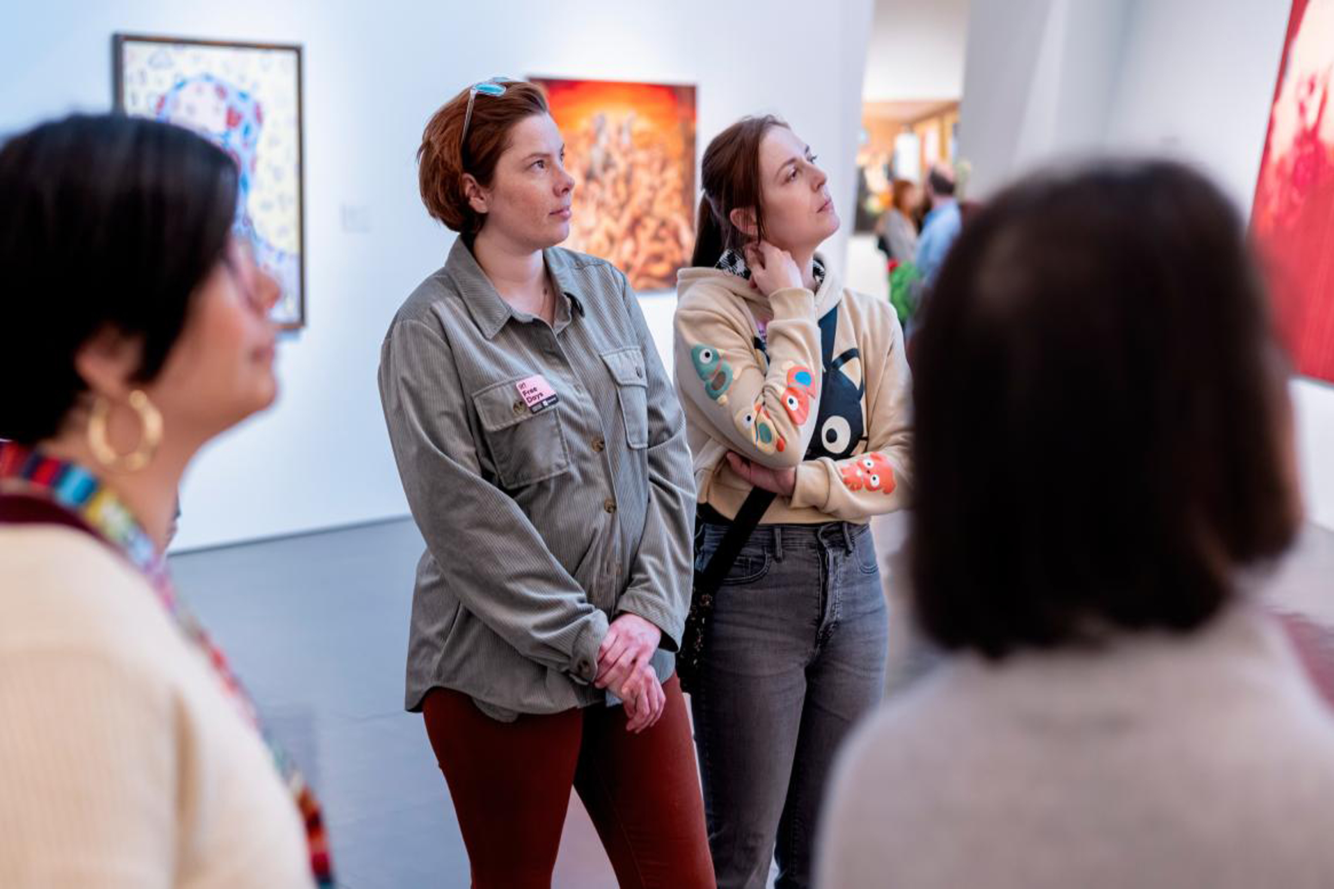 Group of women examining an artwork