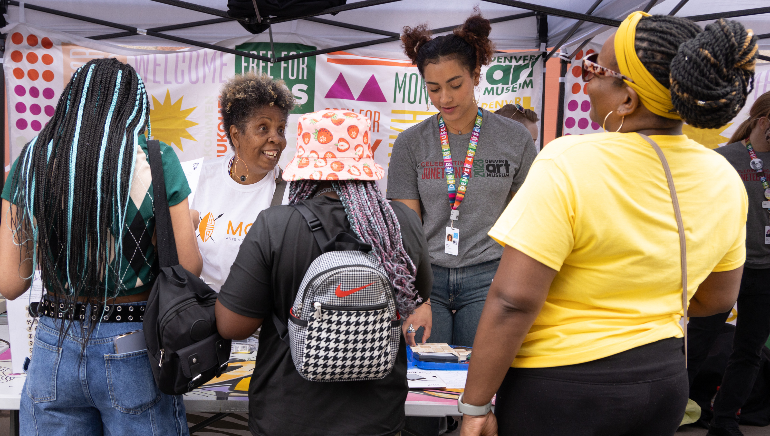 people talking at the museum's Juneteenth booth