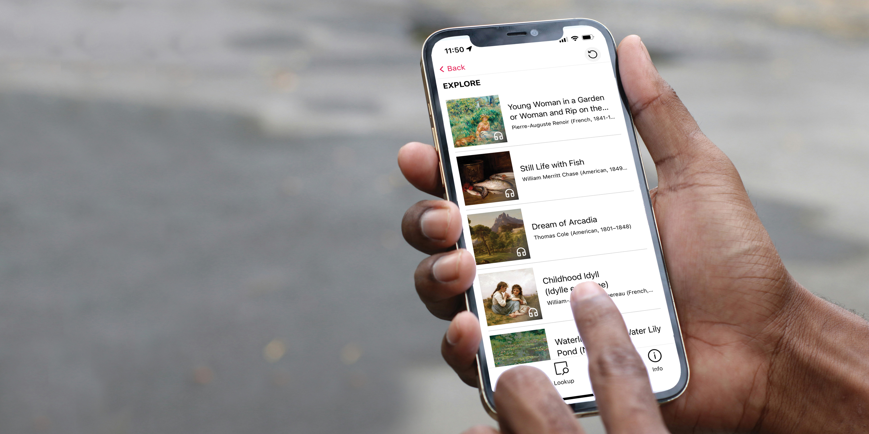 Hand holding a phone displaying the Bloomberg Connects digital guide