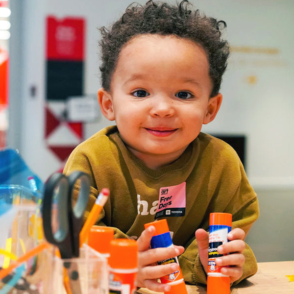 Young boy holding a glue stick