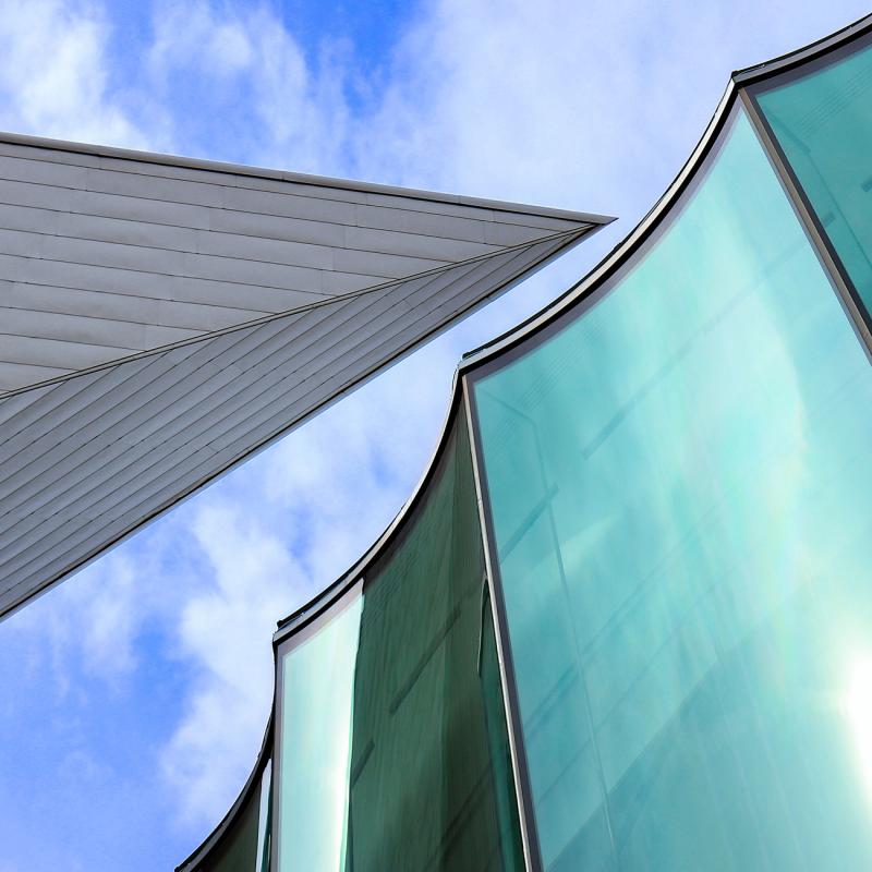 Exterior view of the Hamilton Building and the large Sie Welcome Center floor-to-ceiling windows