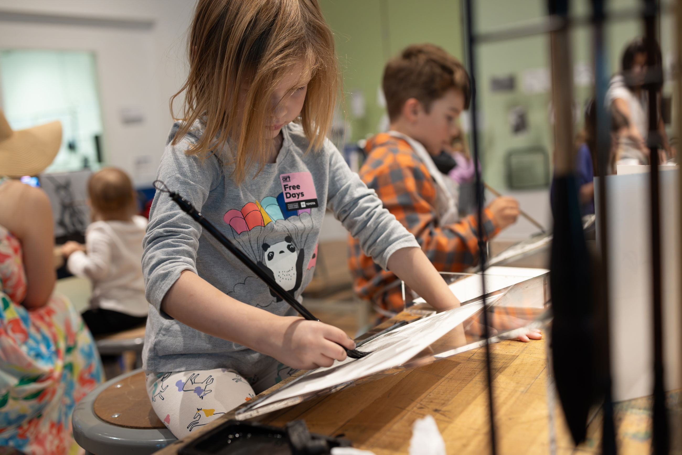 Young girl painting at an easel on a free day