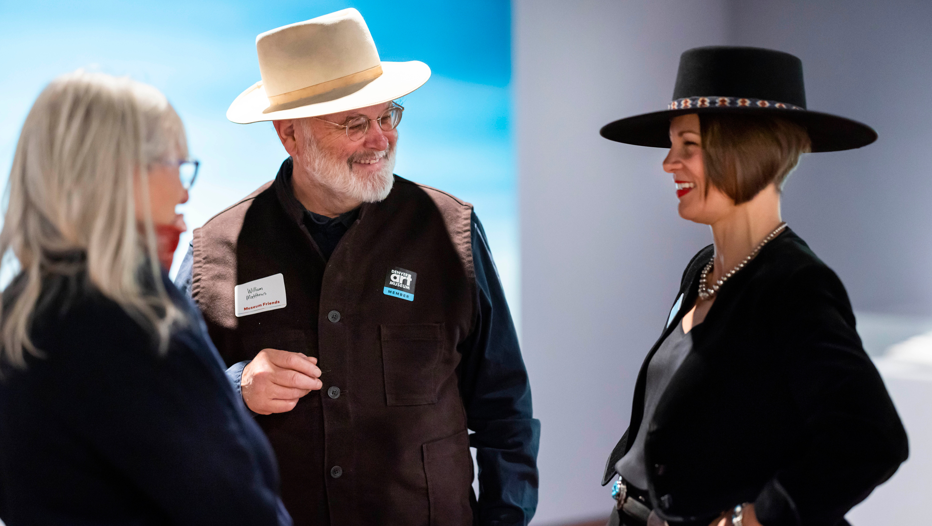 Curator mingling with two adult visitors