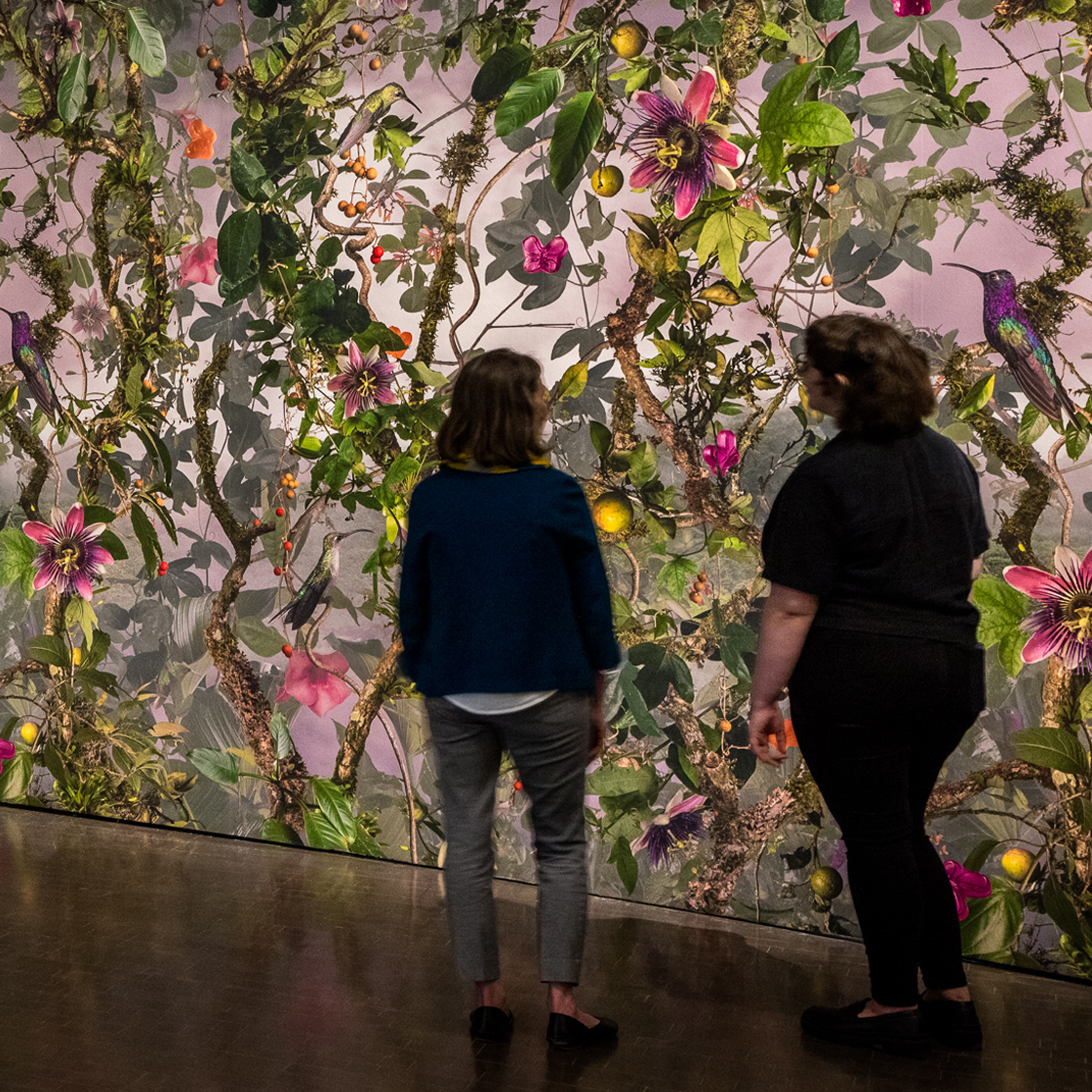 2 people in front of an installation in Biophilia