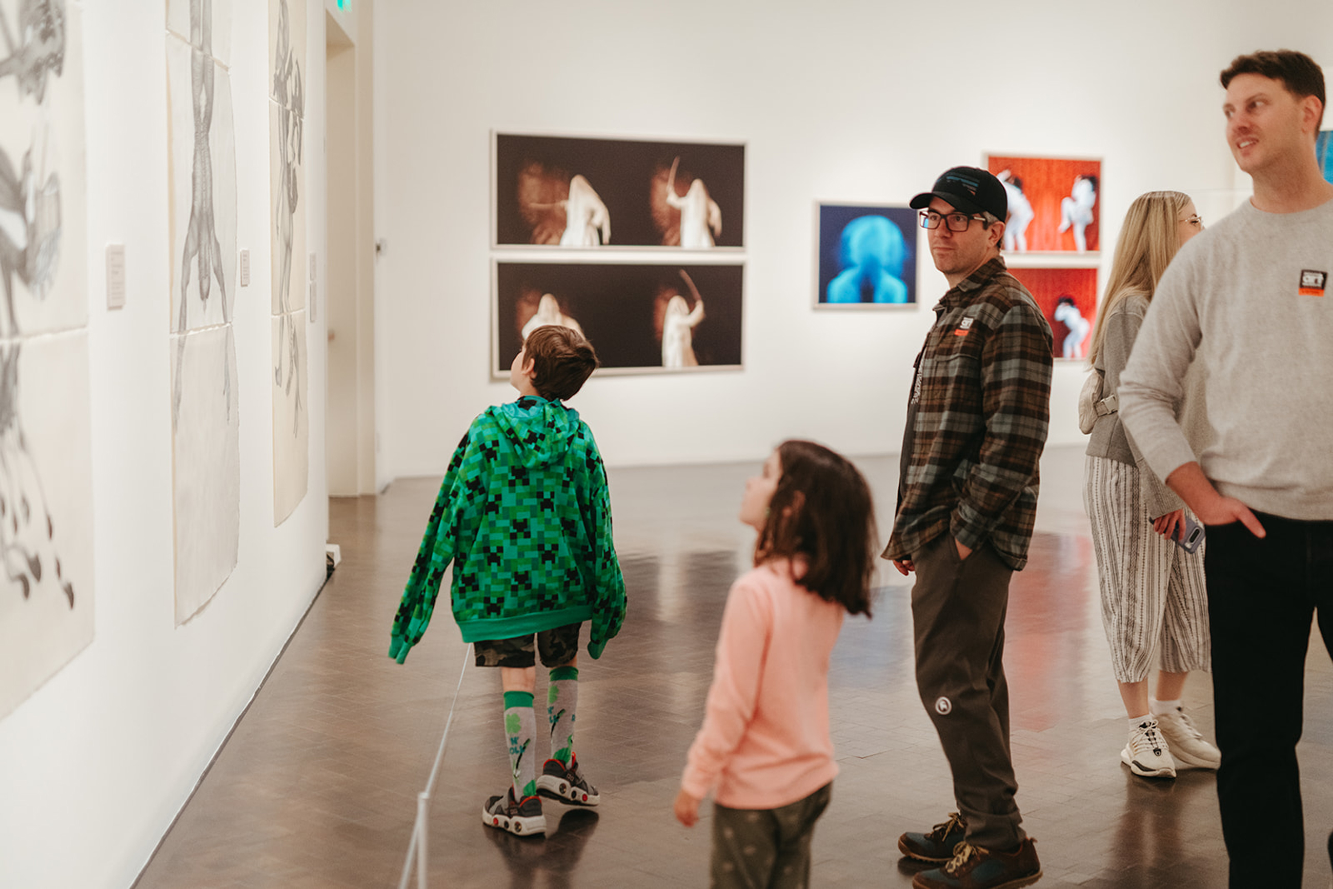 Group of visitors looking at art in the gallery