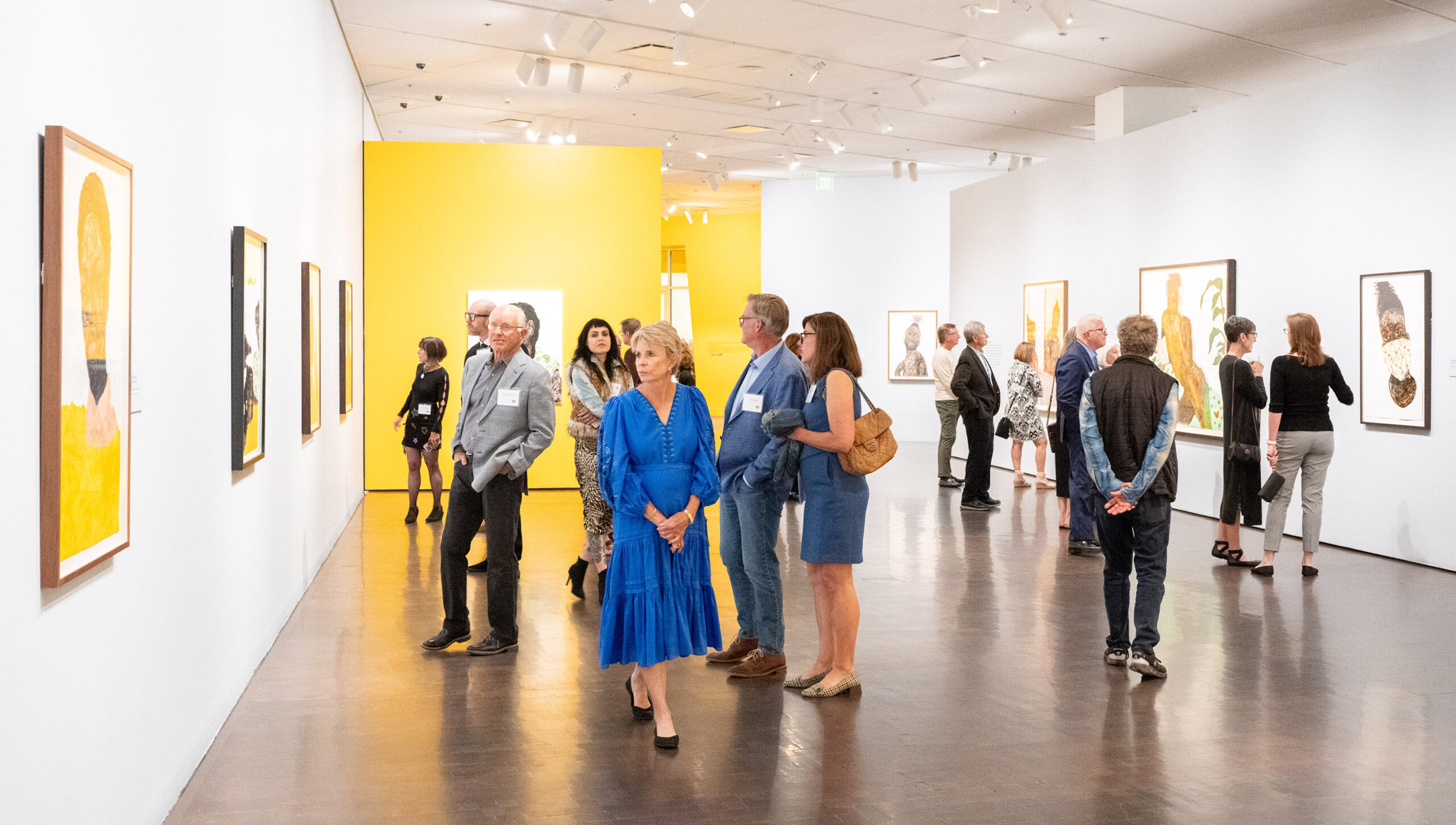 Group of patrons looking at art in the galleries