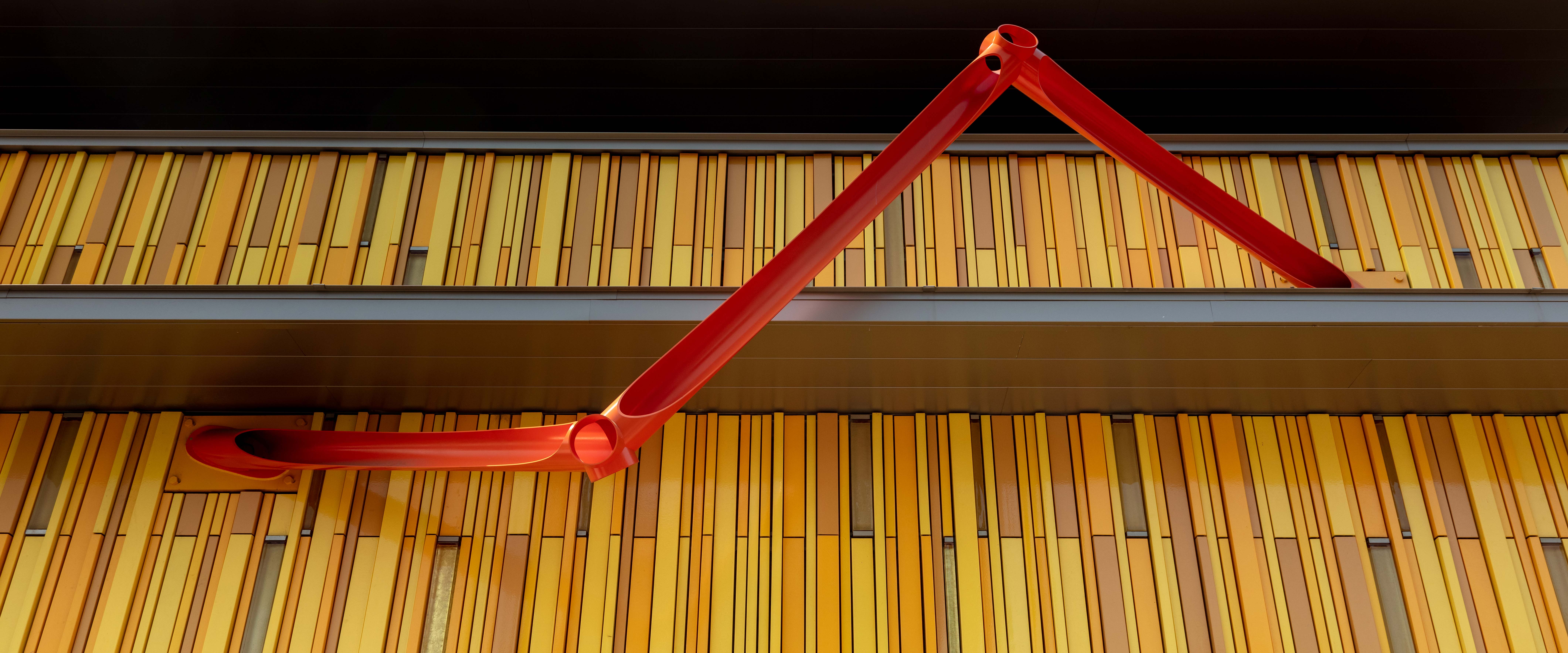 Abstract red steel sculptue adorning the outside of the Kirkland Museum building