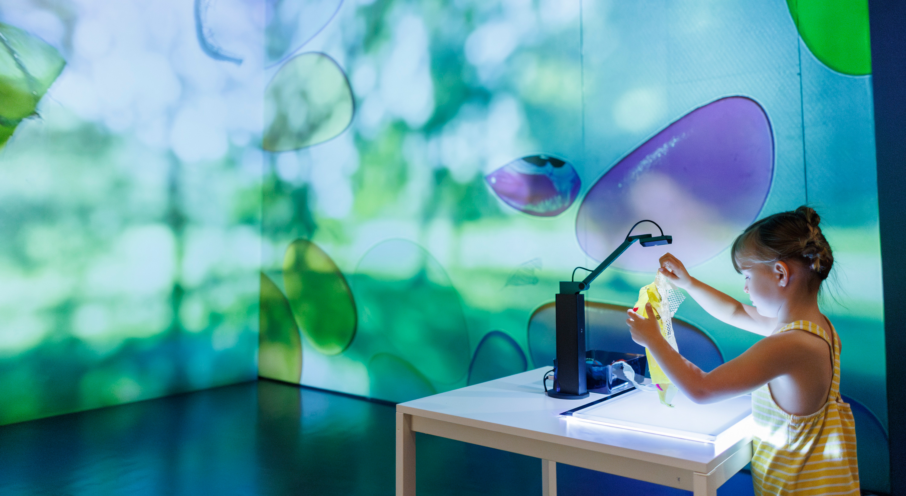 Girl playing with a projector activity