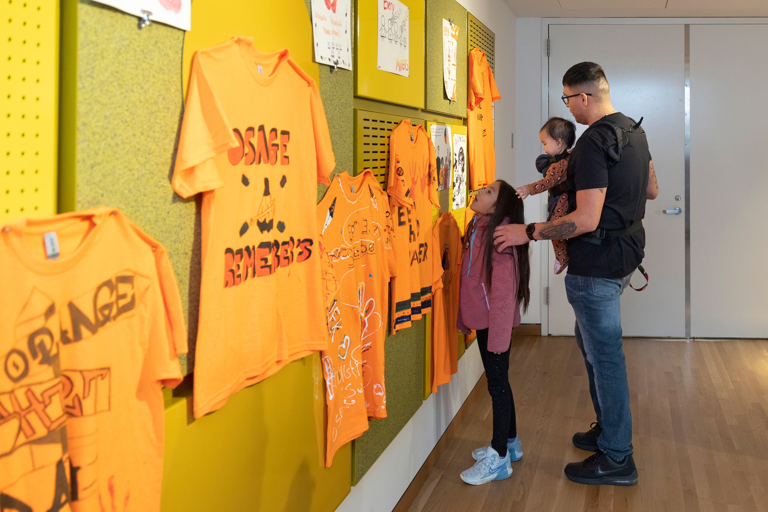Father and his two kids looking at art in the Wonderscape