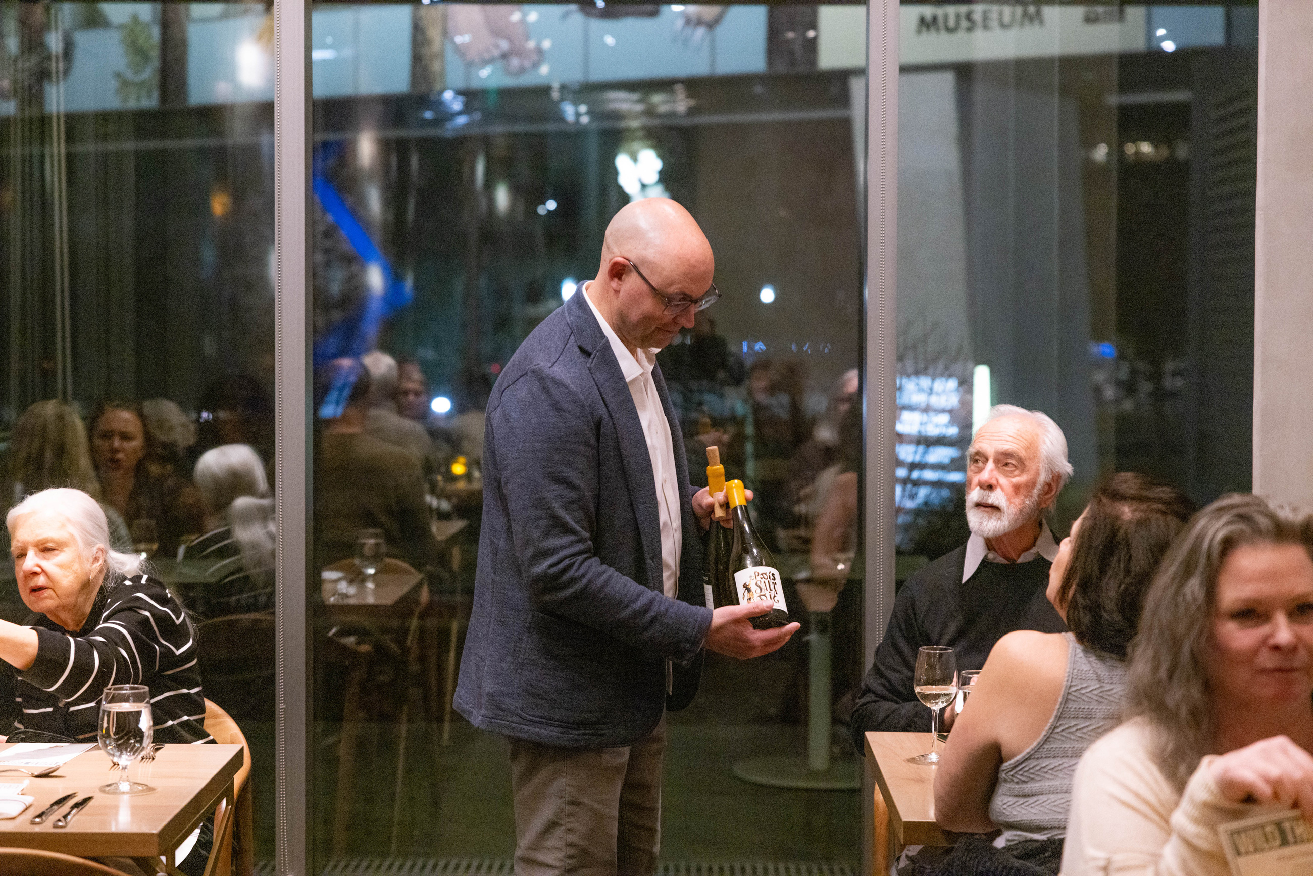 Waiter presenting a bottle of wine to the table